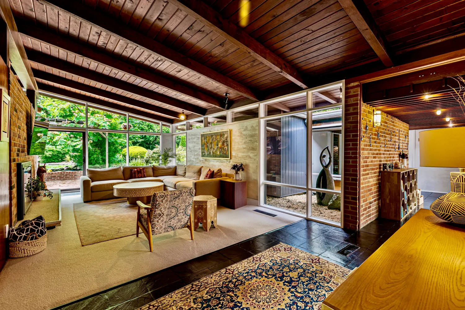 a living room with furniture a fireplace and a table