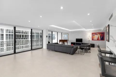 a spacious bedroom with a bed and glass couch