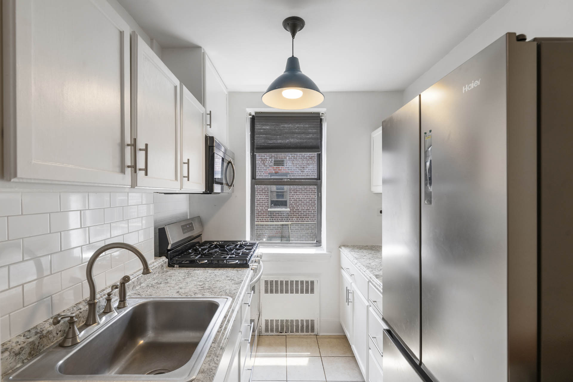 2420 Morris Avenue, Unit 6K Bronx, NY 10468 - Photo 4 of 7 a kitchen with stainless steel appliances a refrigerator sink and cabinets
