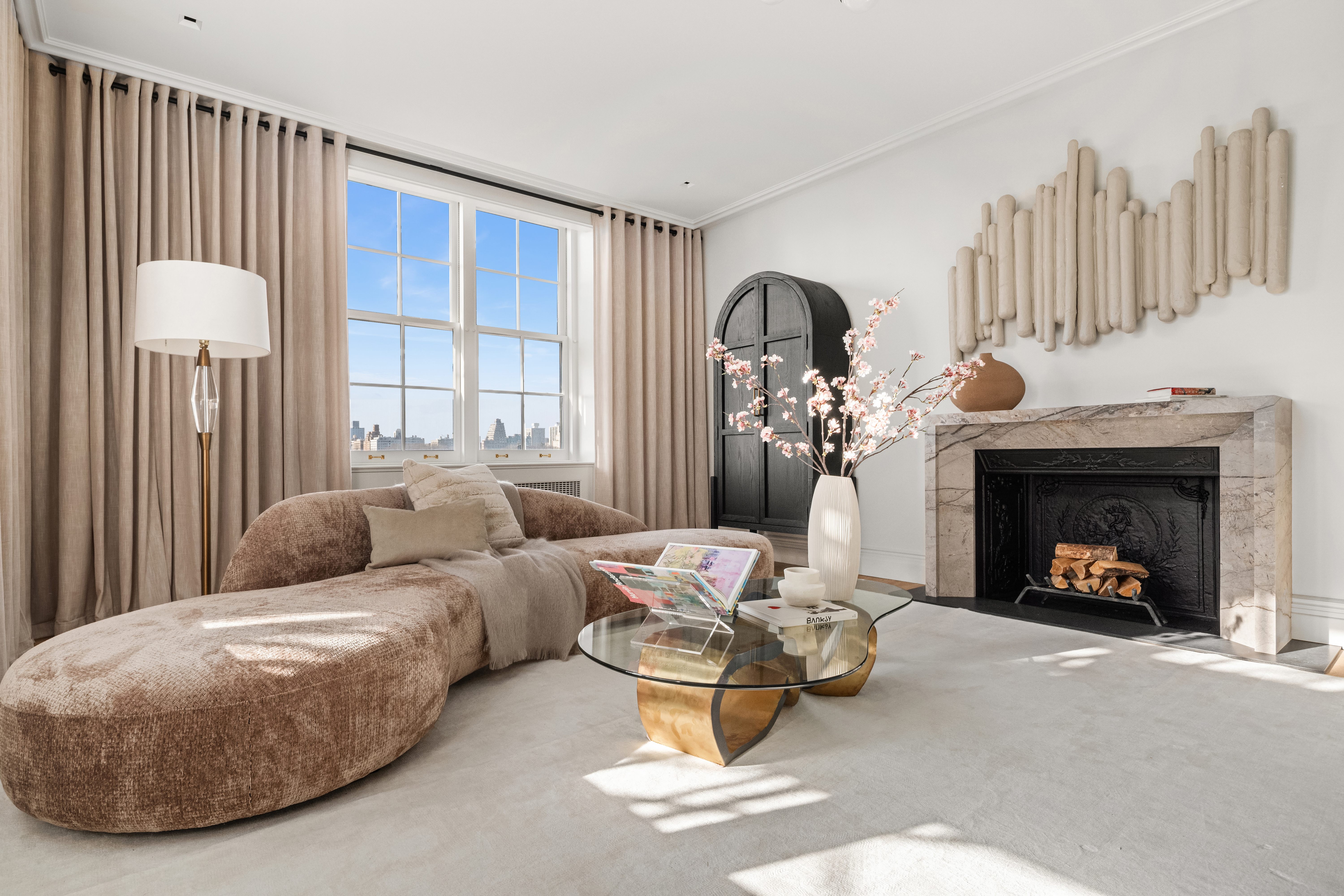 1020 5th Avenue, Unit 9 Manhattan, NY 10028 - Photo 4 of 27 a living room with furniture and a fireplace