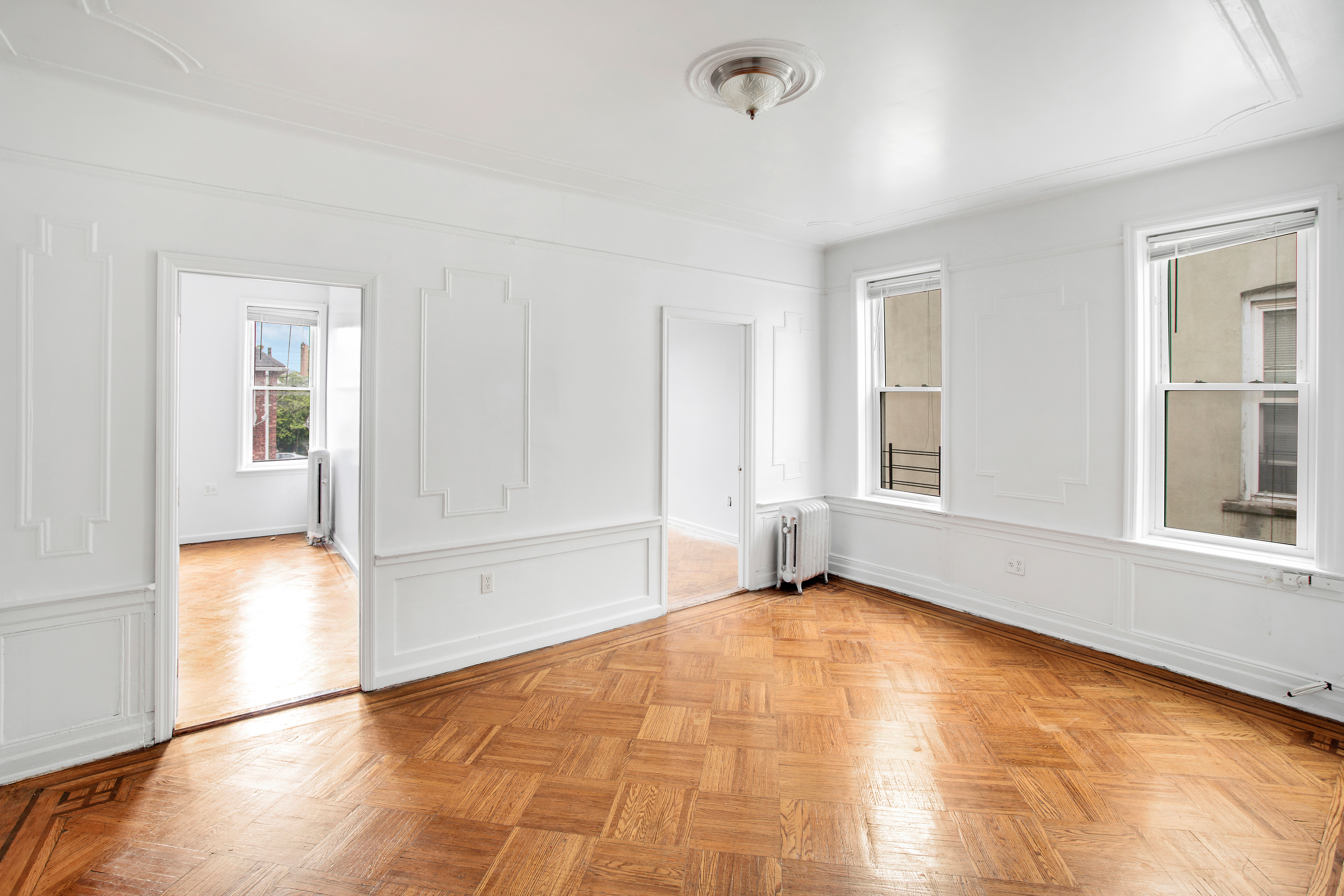 361 East 54th Street, Unit 2R Brooklyn, NY 11203 - Photo 3 of 9 a view of an empty room with window and wooden floor