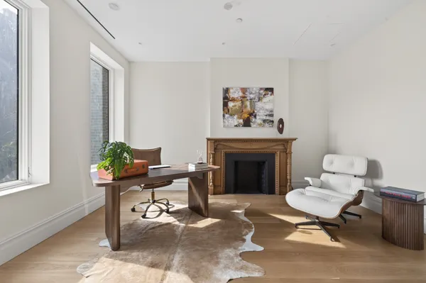 a living room with furniture a window and a fireplace