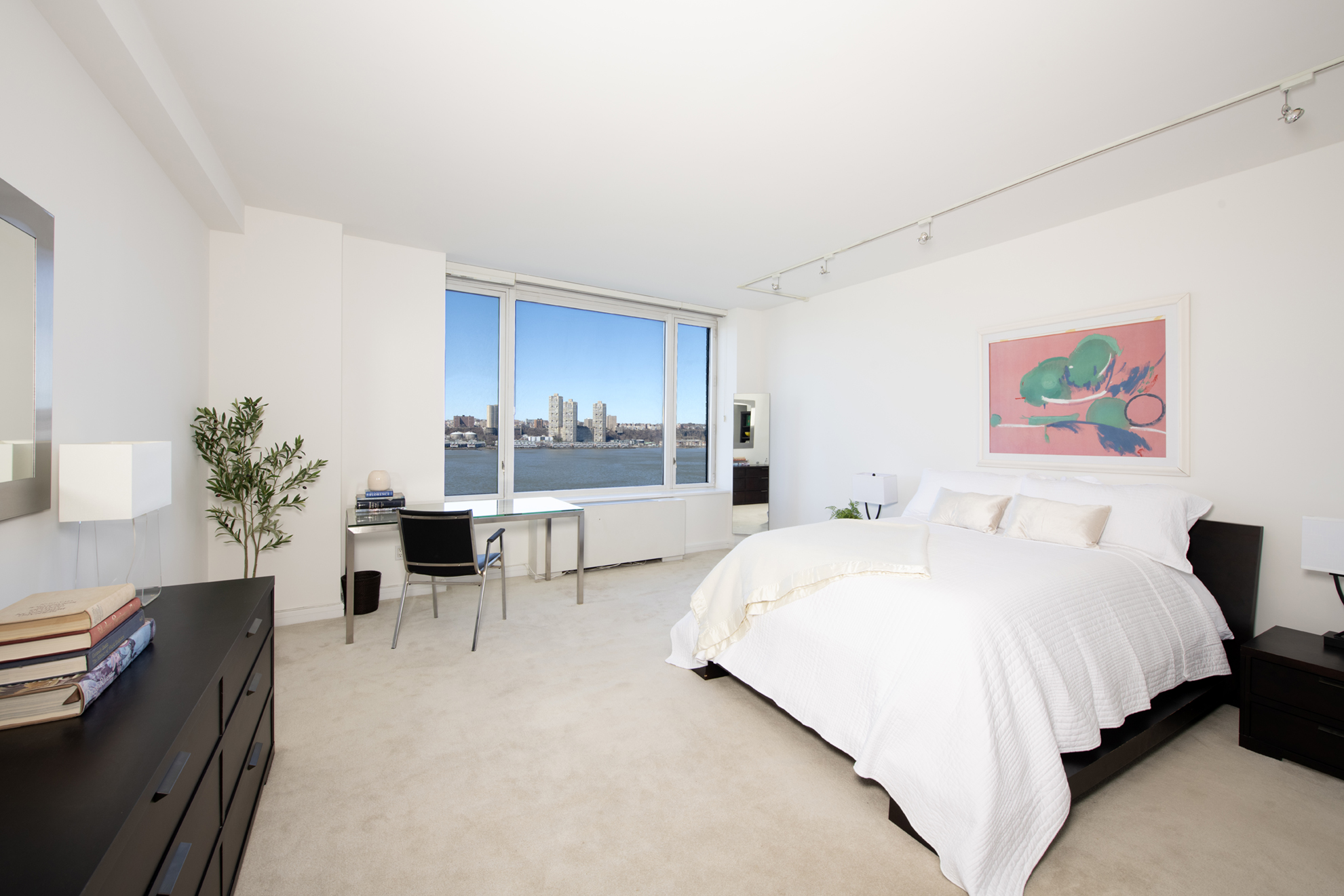 220 Riverside Boulevard, Unit 9K Manhattan, NY 10069 - Photo 5 of 8 a spacious bedroom with a bed and a cabinets