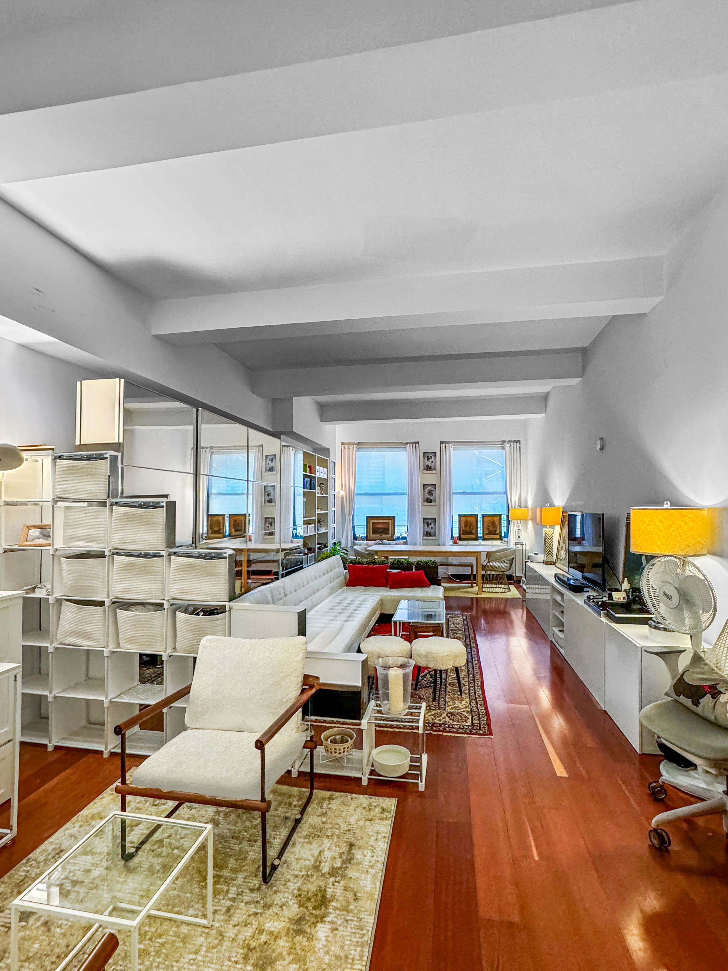 80 John Street, Unit 10D Manhattan, NY 10038 - Photo 4 of 6 a living room with furniture and a wooden floor