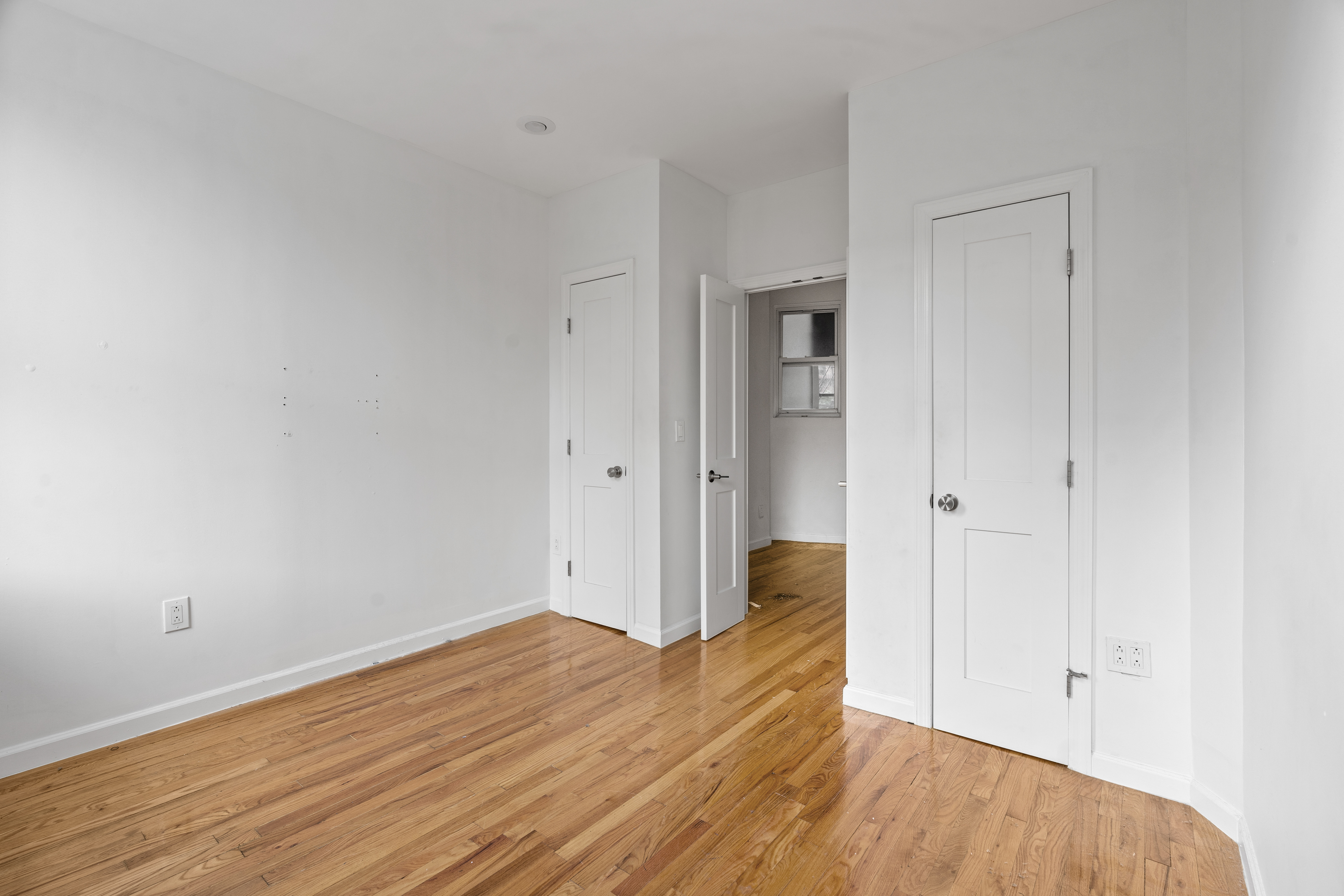 746 9th Avenue, Unit 4DF Manhattan, NY 10019 - Photo 7 of 13 a view of an empty room with wooden floor