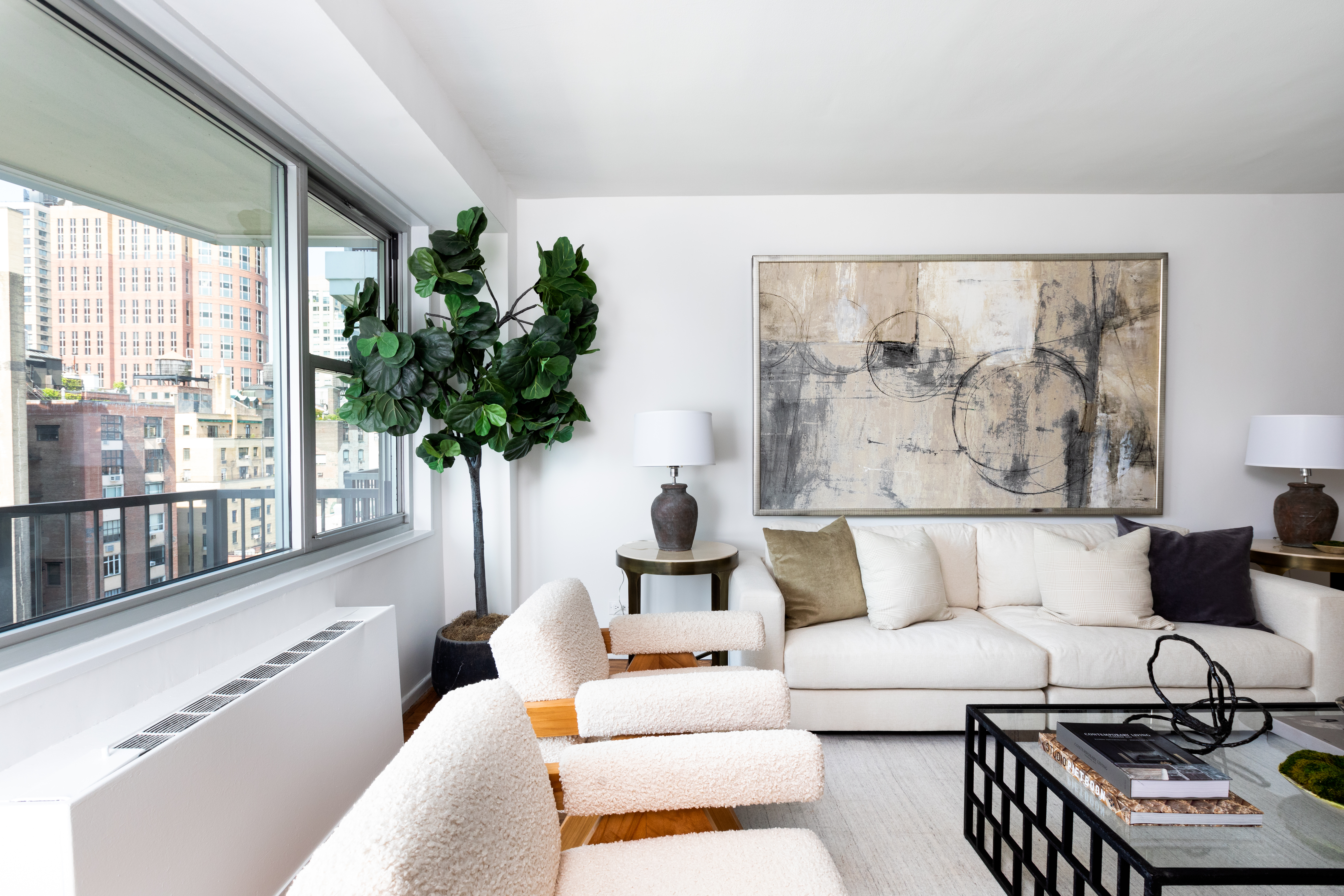 80 Central Park West, Unit 12C Manhattan, NY 10023 - Photo 8 of 27 a living room with furniture and a large window with potted plants