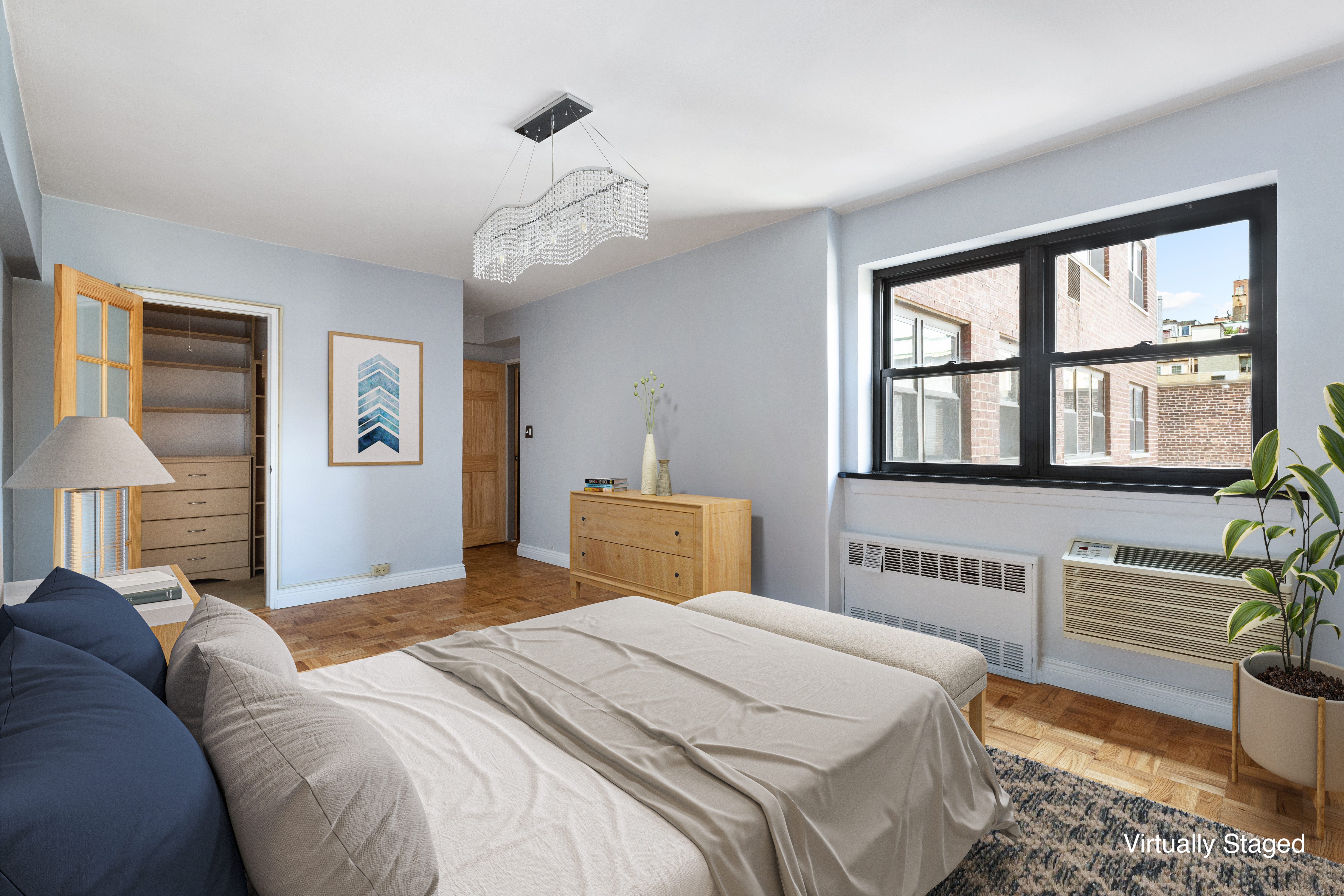181 East 73rd Street, Unit 9G Manhattan, NY 10021 - Photo 7 of 17 a bedroom with a large bed and a chandelier