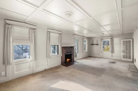 a view of a livingroom with an empty space and a window