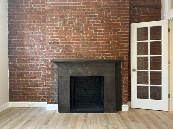 a view of front door of house with wooden floor