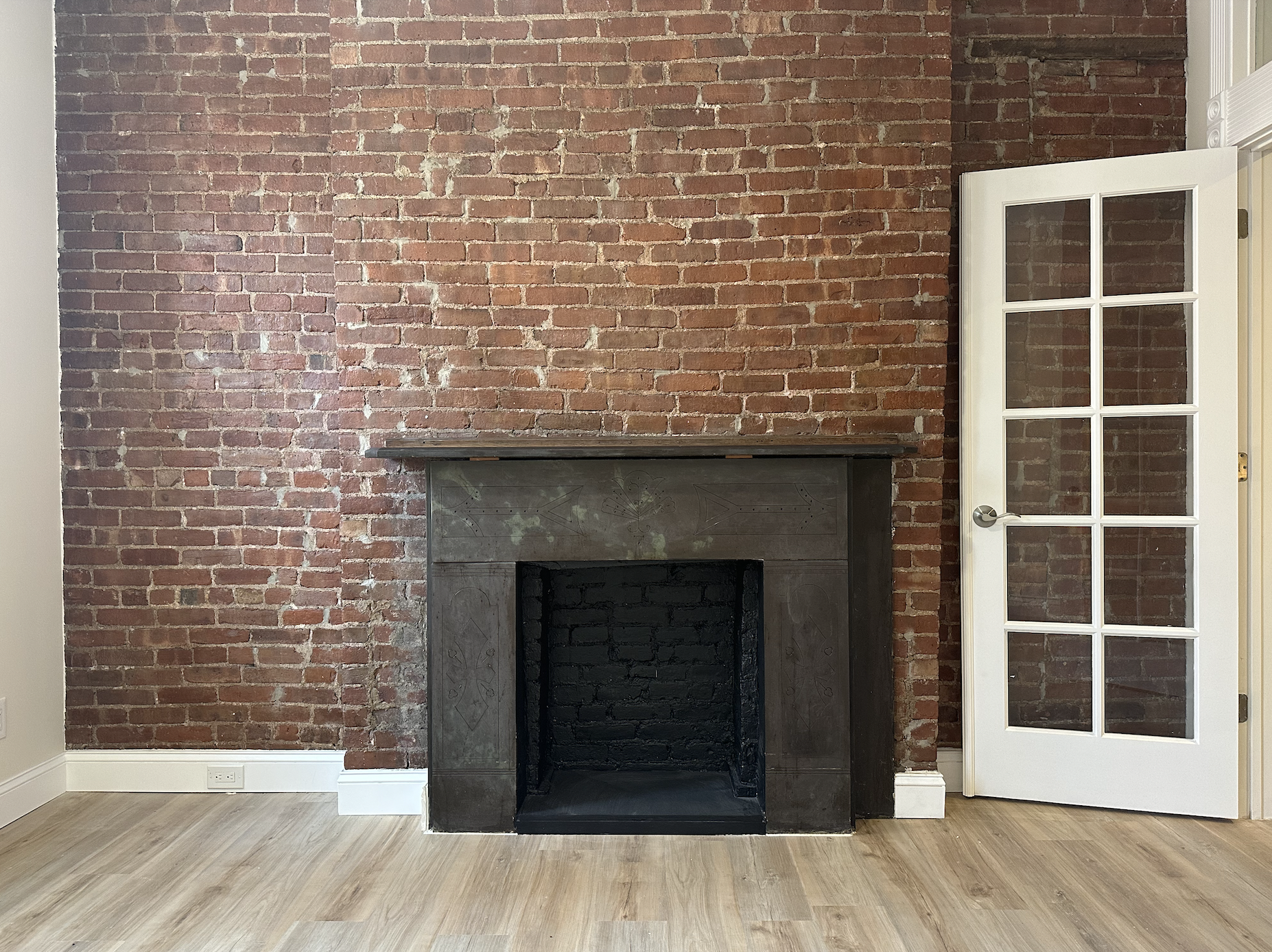 a view of front door of house with wooden floor