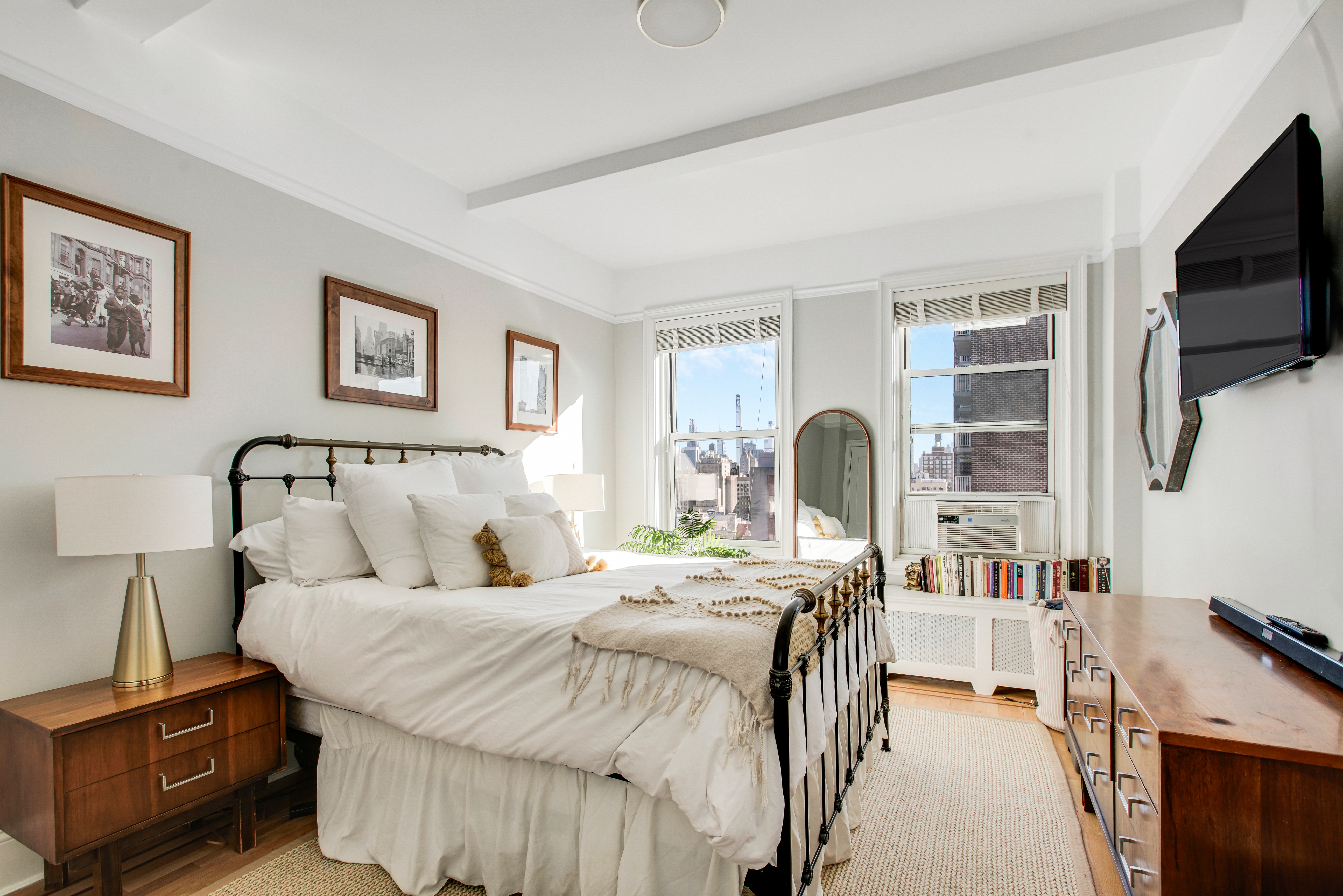 165 West 91st Street, Unit 15B Manhattan, NY 10024 - Photo 8 of 24 a bedroom with a bed and a flat tv screen on the dresser