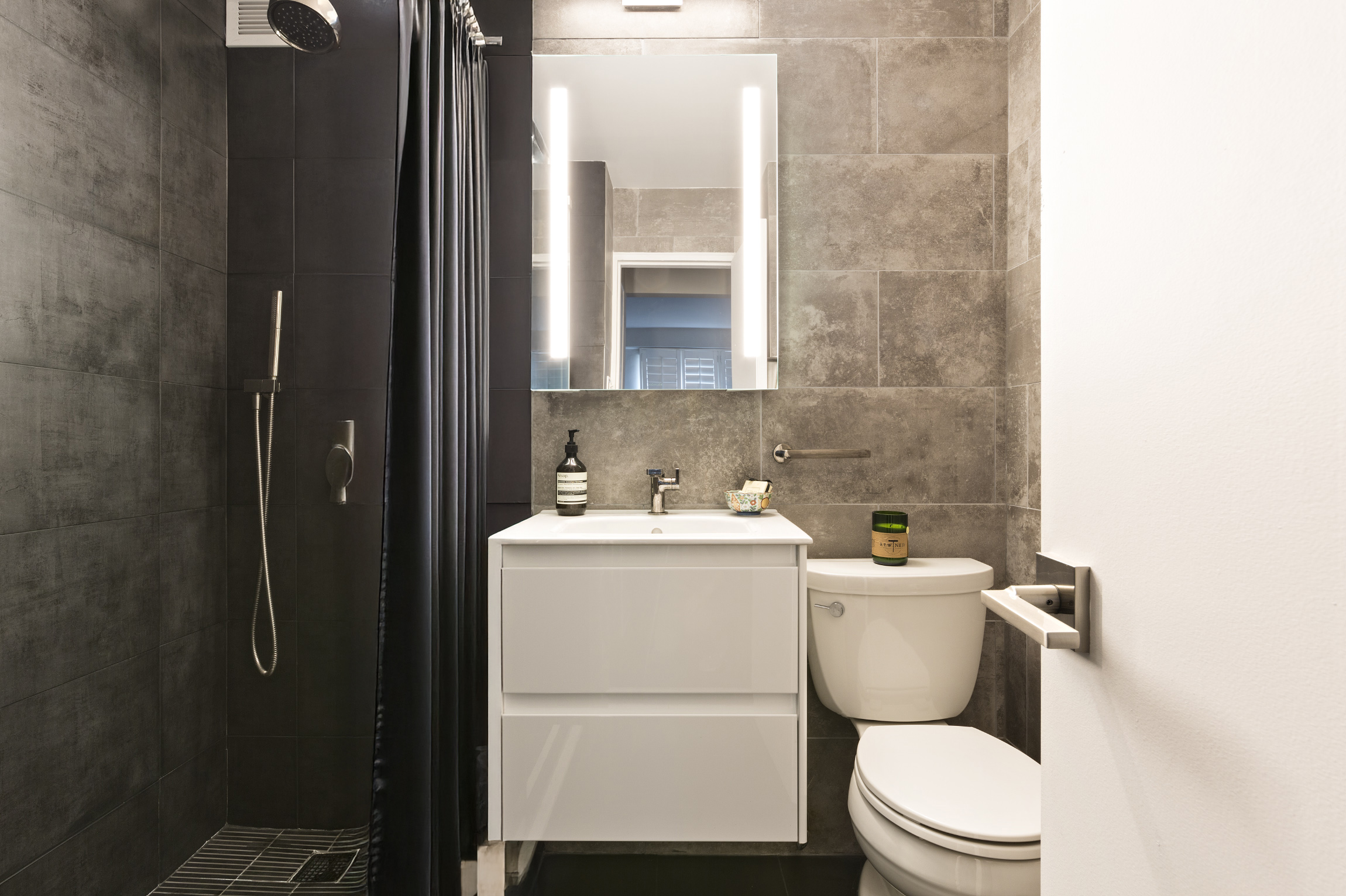 101 West 12th Street, Unit 6L Manhattan, NY 10011 - Photo 5 of 11 a white toilet sitting next to a bathroom sink