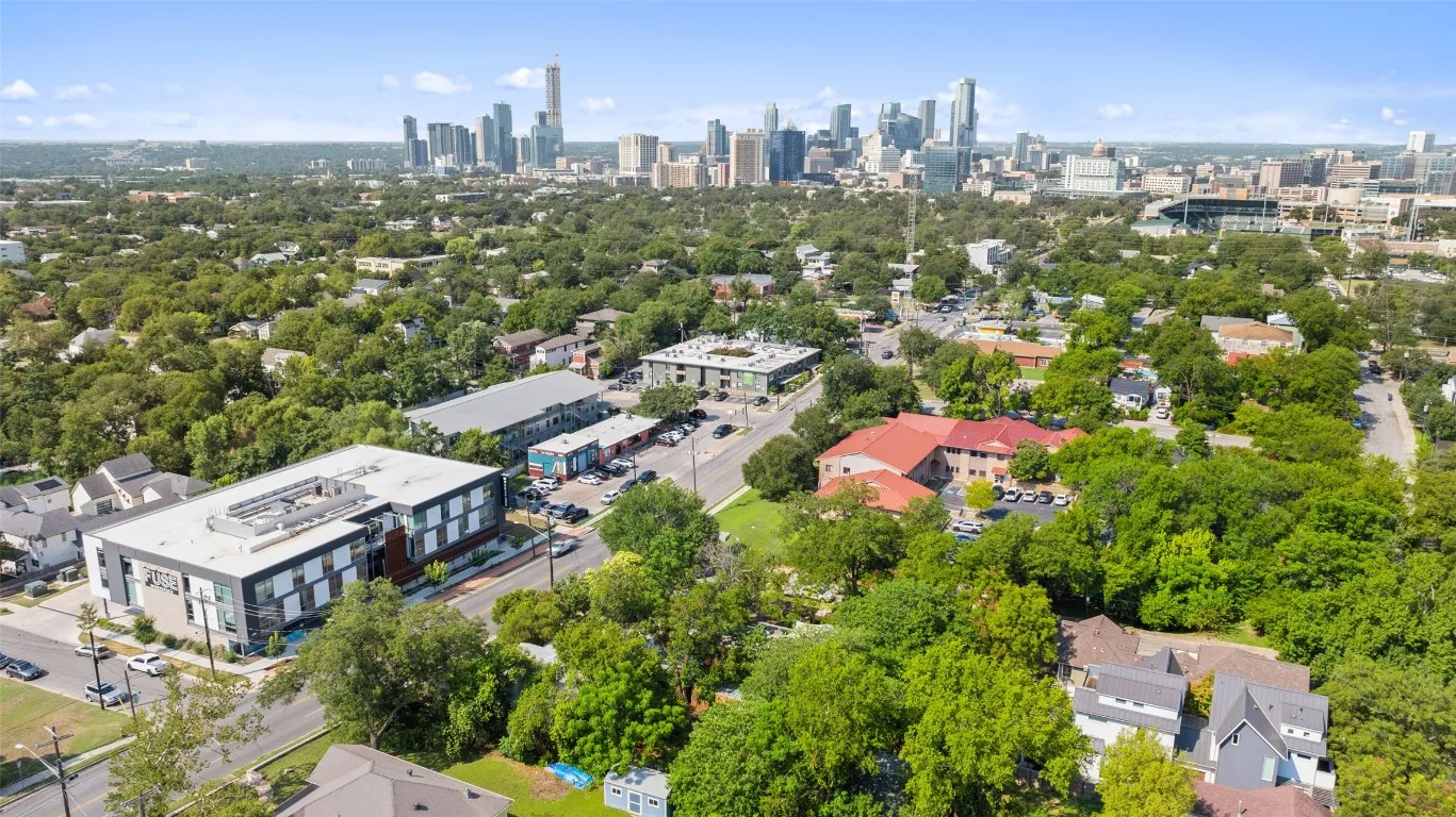 an aerial view of residential houses with city view