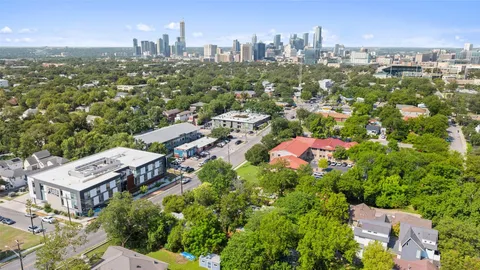 an aerial view of residential houses with city view