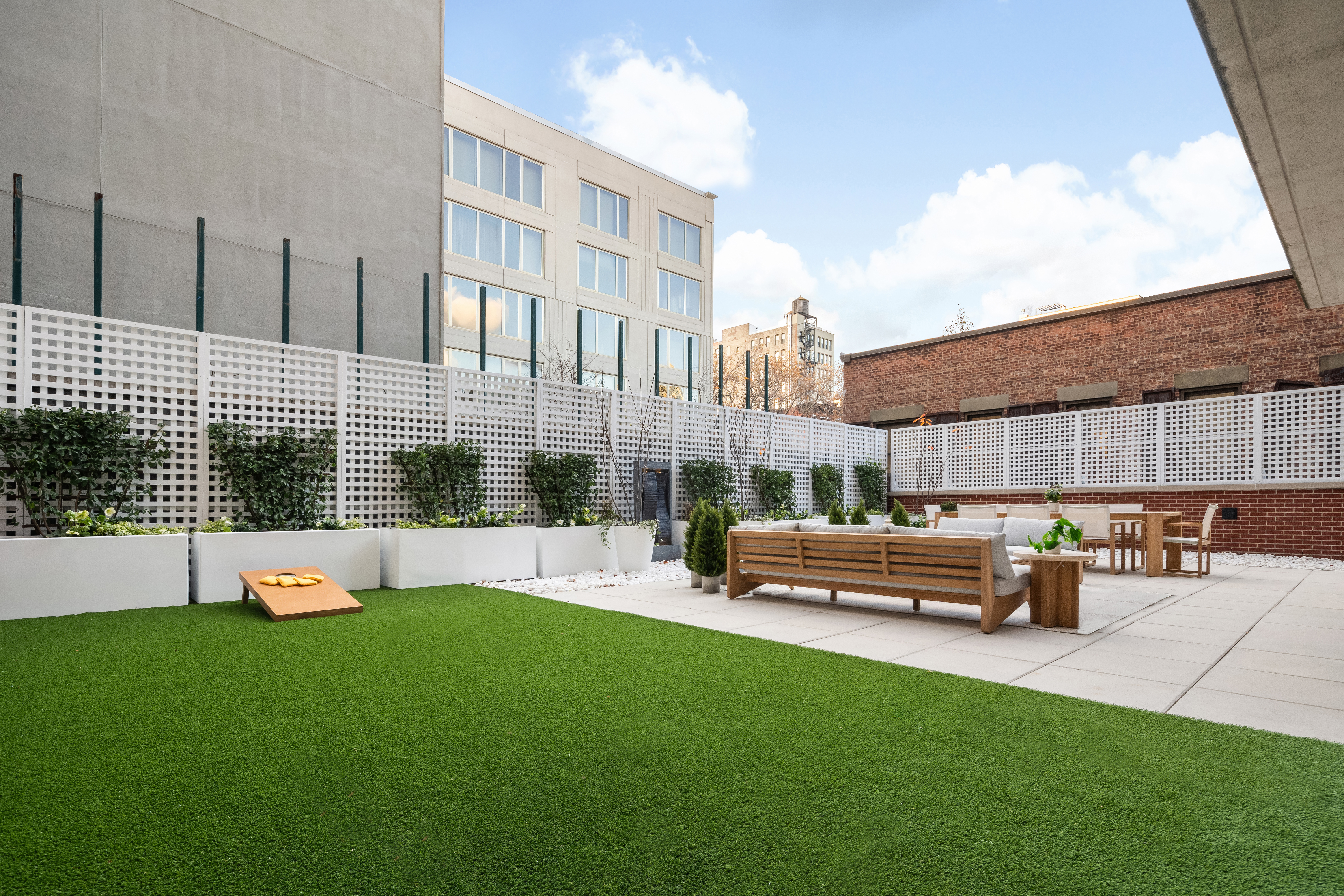 199 Mott Street, Unit 2 Manhattan, NY 10012 - Photo 8 of 14 a view of a house with a yard and sitting area