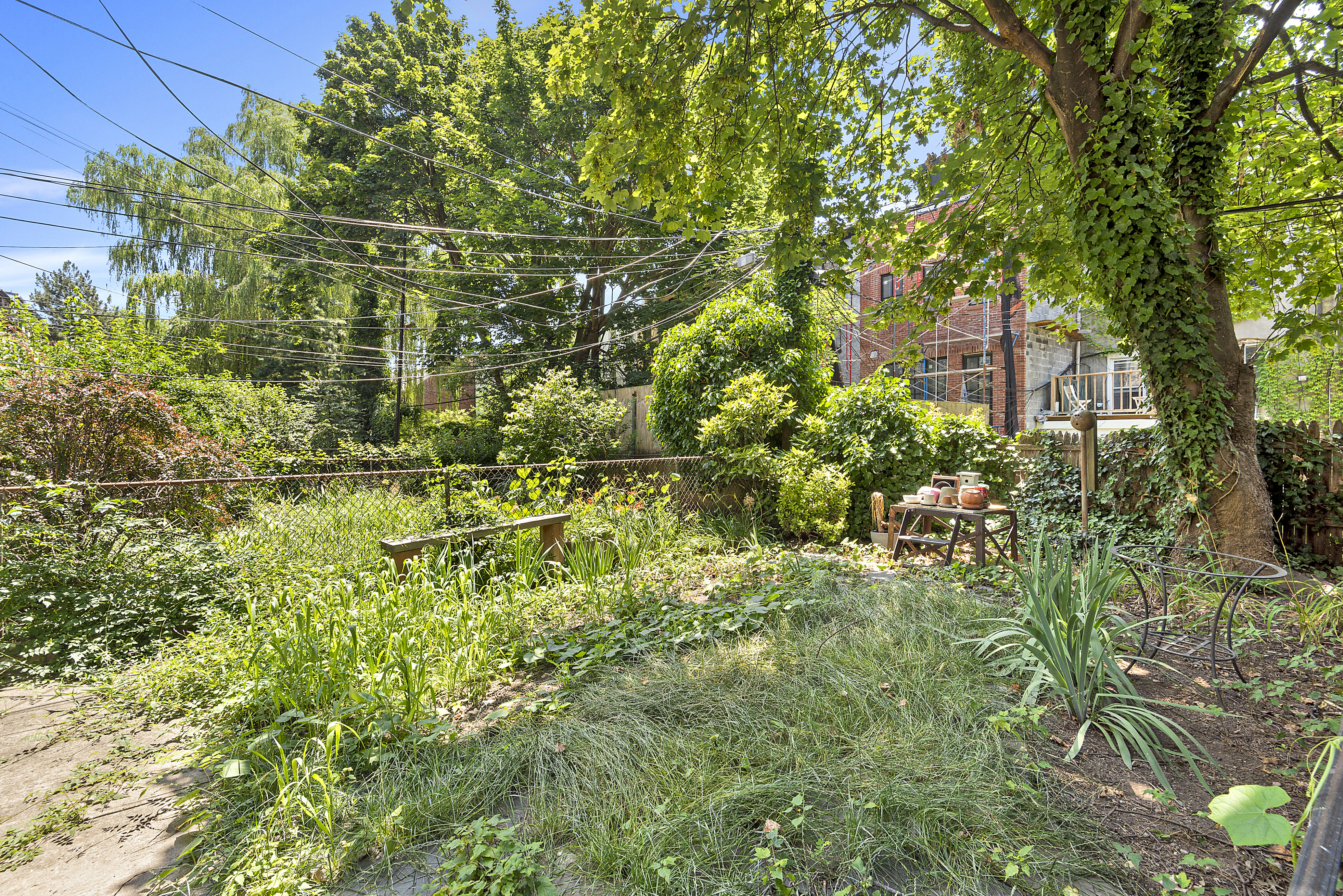 104 Dean Street, Unit 1R Brooklyn, NY 11201 - Photo 6 of 7 a backyard of a house with lots of green space and a fountain