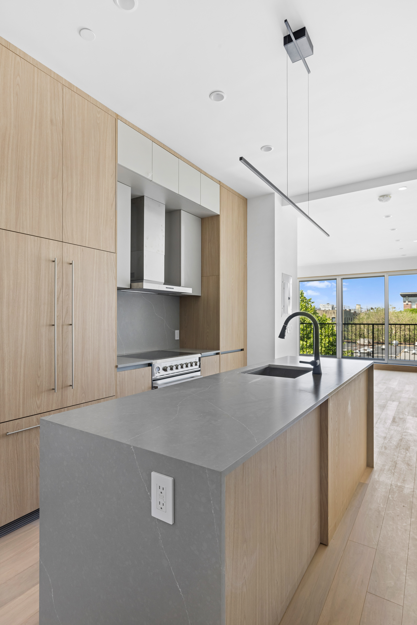 810 Sterling Place, Unit PH Brooklyn, NY 11216 - Photo 2 of 16 a kitchen with stainless steel appliances granite countertop a sink a stove and a refrigerator
