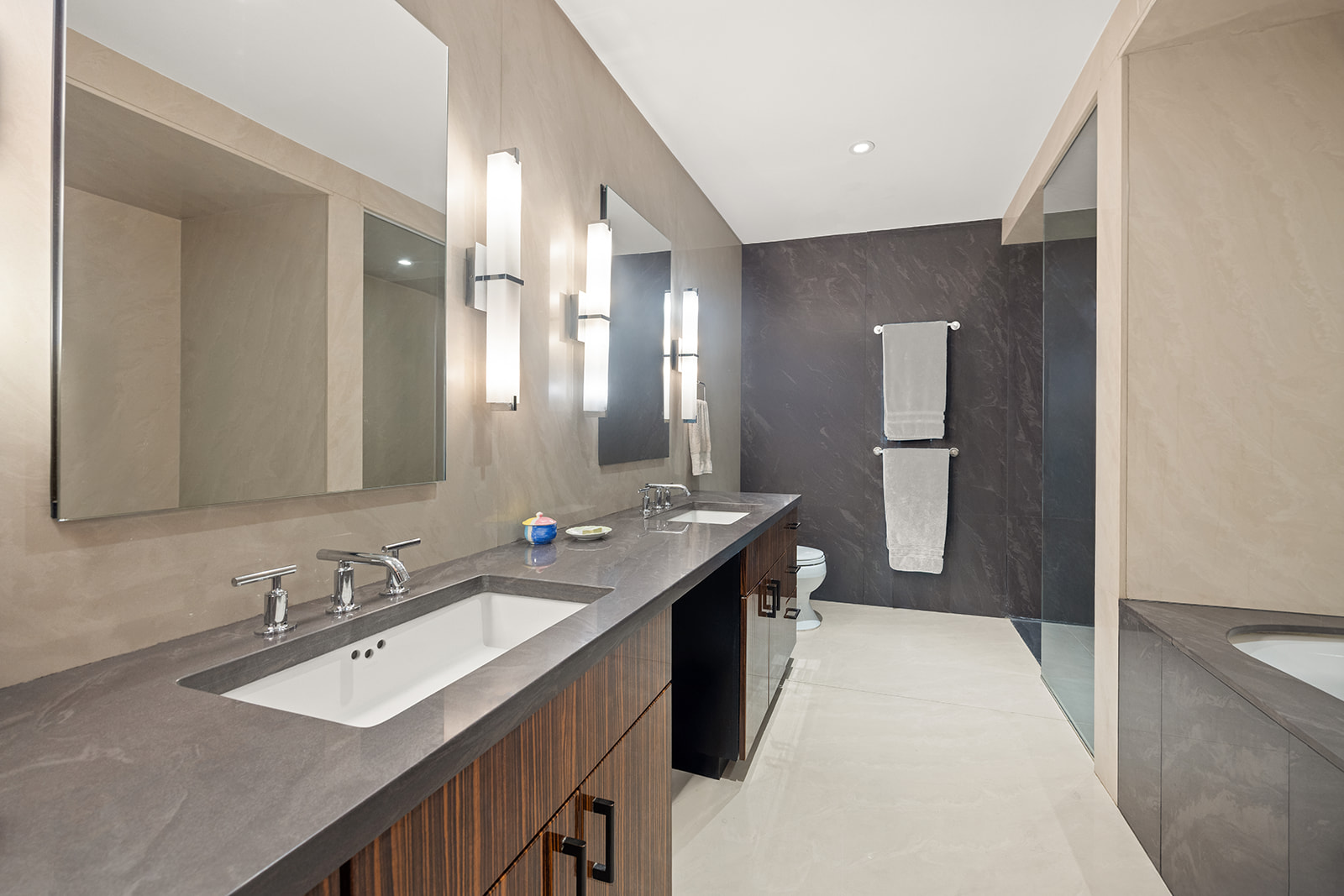 42 Ann Street, Unit 7 Manhattan, NY 10038 - Photo 11 of 16 a spacious bathroom with a double vanity sink a mirror and a bathtub