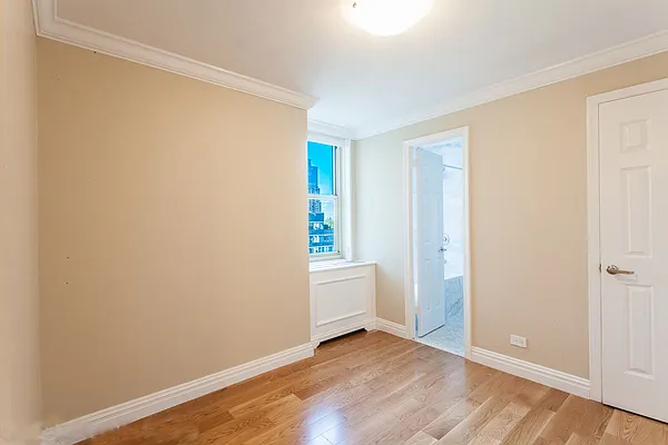 30 West 63rd Street, Unit 28L Manhattan, NY 10023 - Photo 9 of 11 a view of an empty room with closet and a window