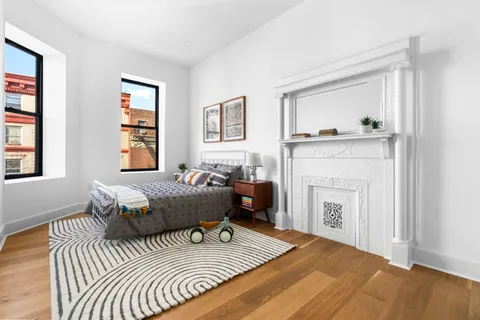 a bedroom with a bed and a fireplace