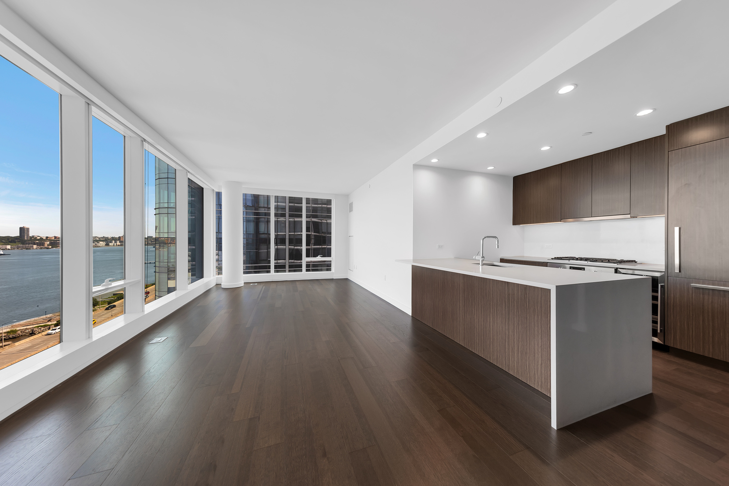 30 Riverside Boulevard, Unit 1414 Manhattan, NY 10069 - Photo 1 of 25 a kitchen with stainless steel appliances granite countertop a large counter top a wooden floors and a large window