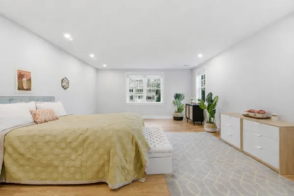 a spacious bedroom with a bed and a couch