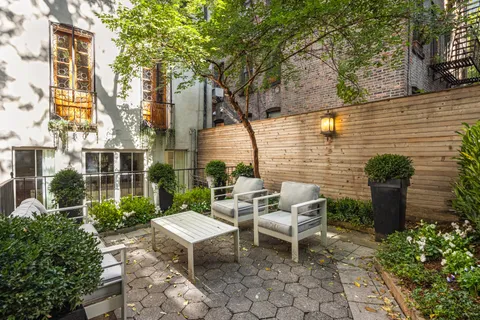 a view of a patio with table and chairs and potted plants