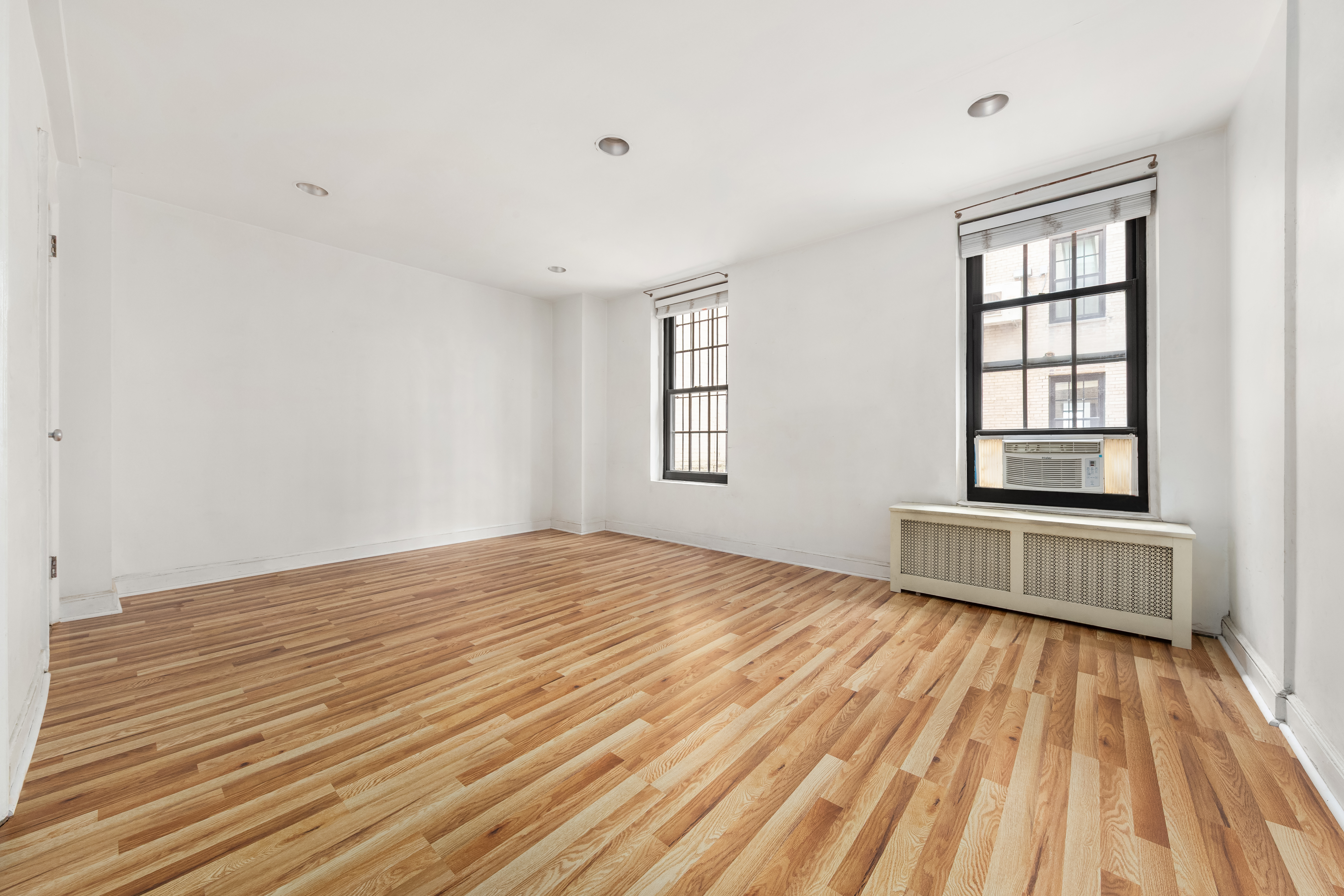 1 5th Avenue, Unit 2B Manhattan, NY 10003 - Photo 7 of 12 a view of empty room with wooden floor and fan