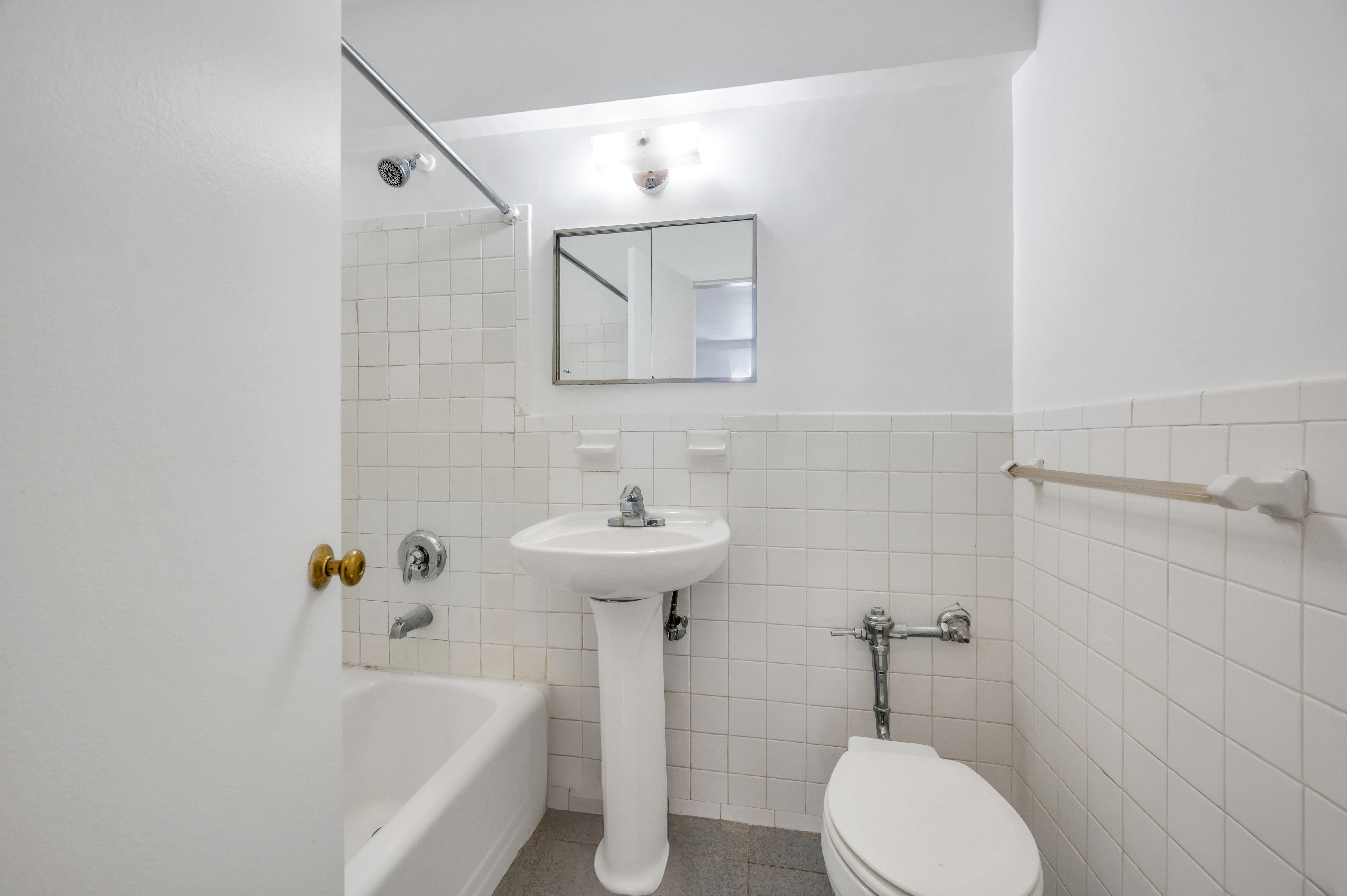 200 East 28th Street, Unit 6F Manhattan, NY 10016 - Photo 6 of 9 a bathroom with a sink a toilet and bathtub