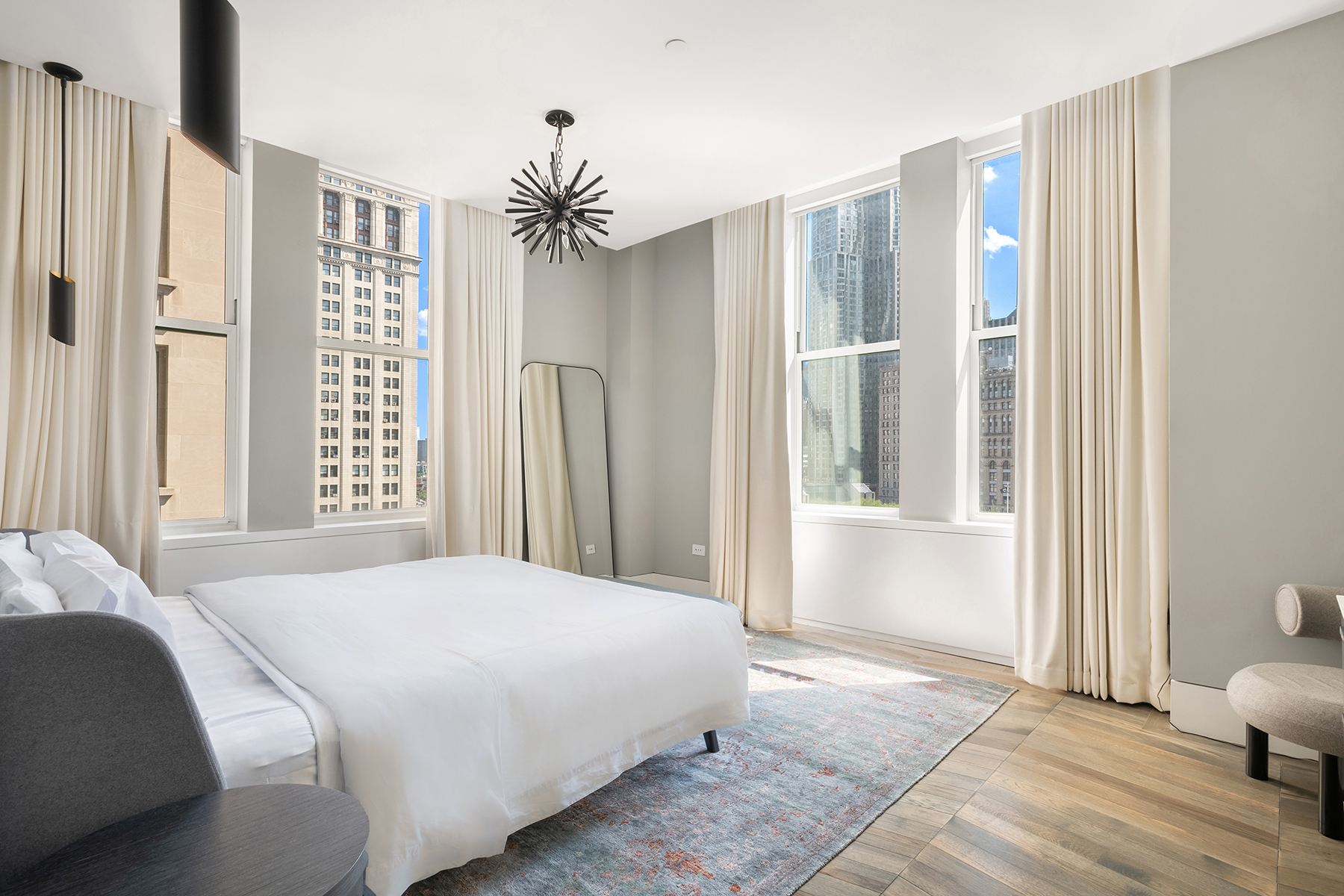 49 Chambers Street, Unit 11D Manhattan, NY 10007 - Photo 8 of 30 a bedroom with a large bed and a window