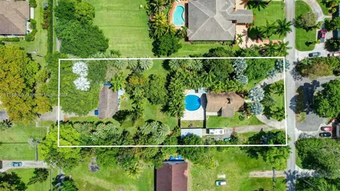 a view of a backyard with sitting area