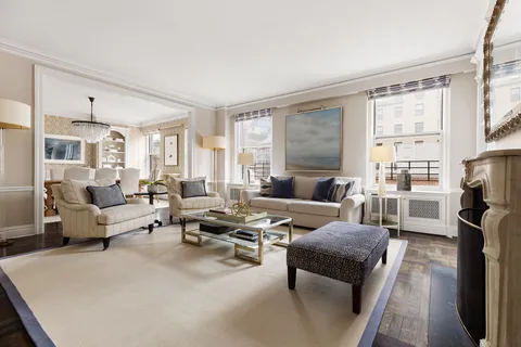 a living room with furniture wooden floor and a large window