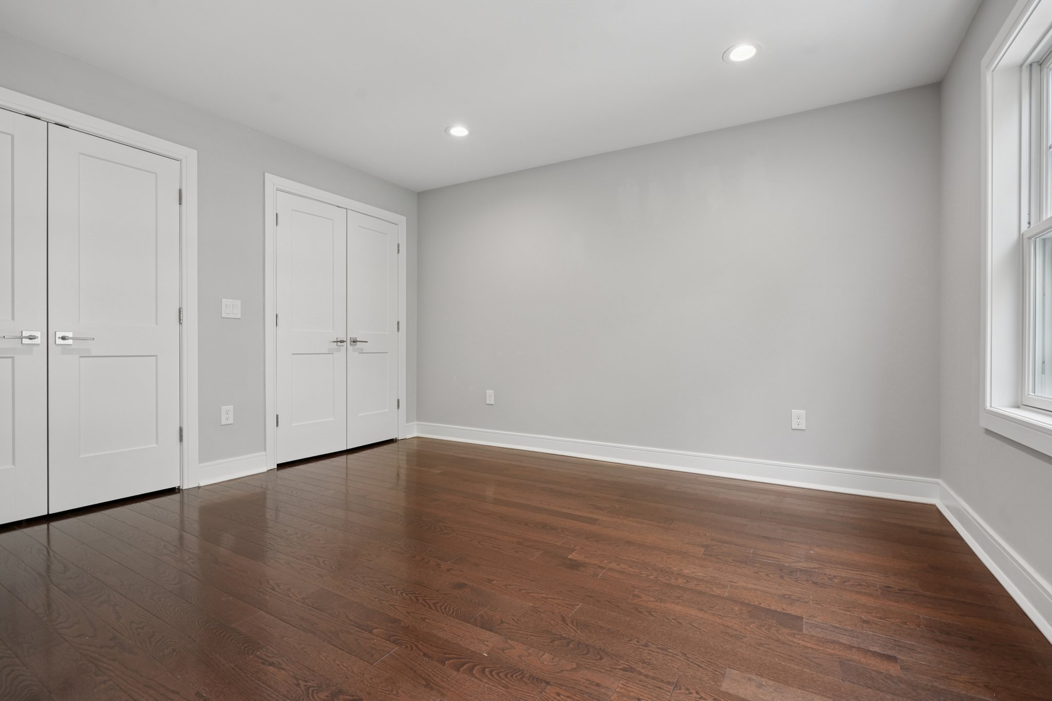 823 River Road Chatham, NJ 07928 - Photo 20 of 60 a view of an empty room with wooden floor and a window
