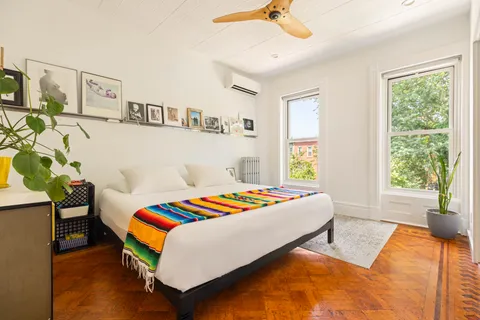 a bedroom with a bed and window