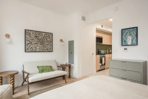 a living room with furniture a refrigerator and a couch