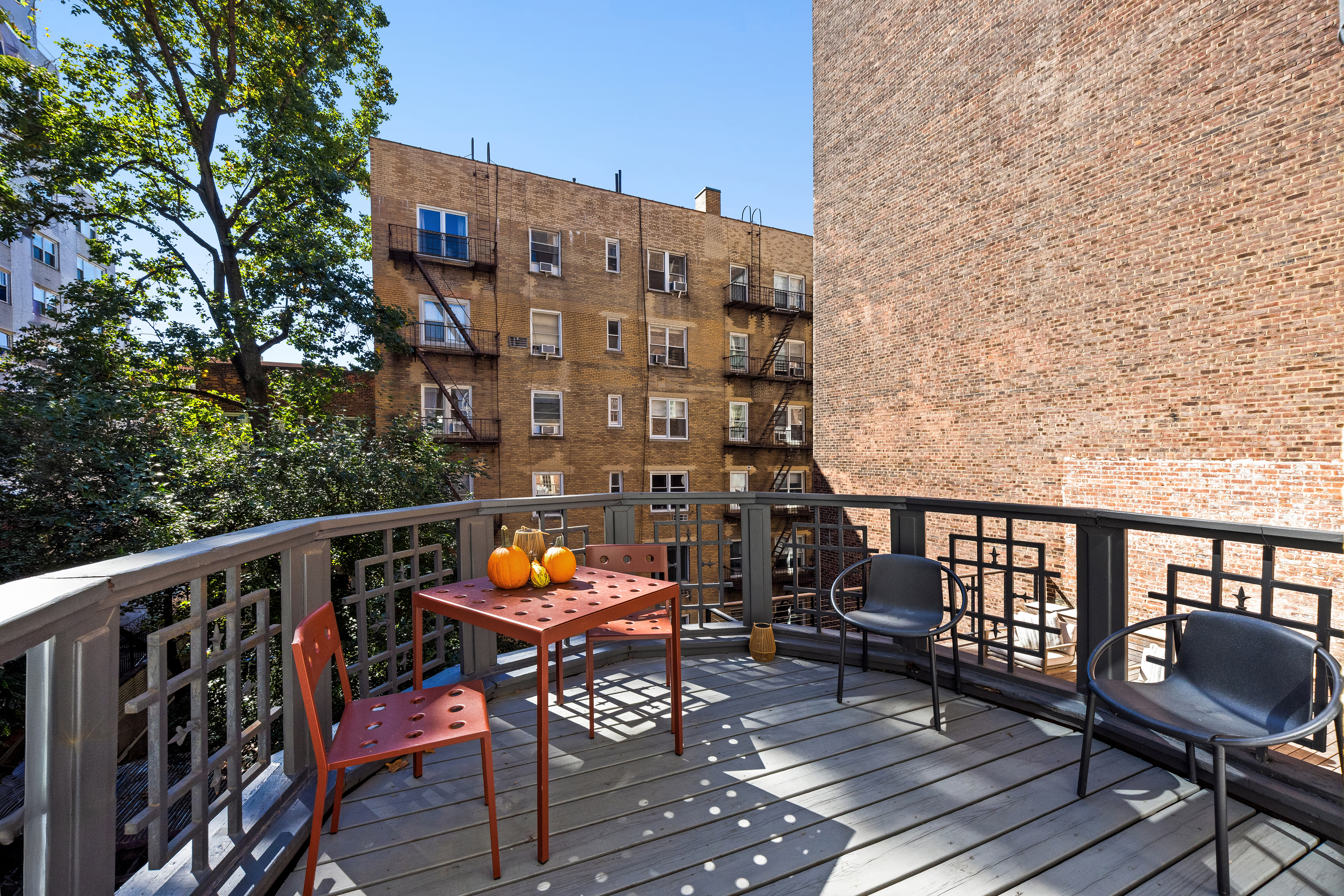 112 West 13th Street Manhattan, NY 10011 - Photo 27 of 46 a balcony with wooden benches and bench