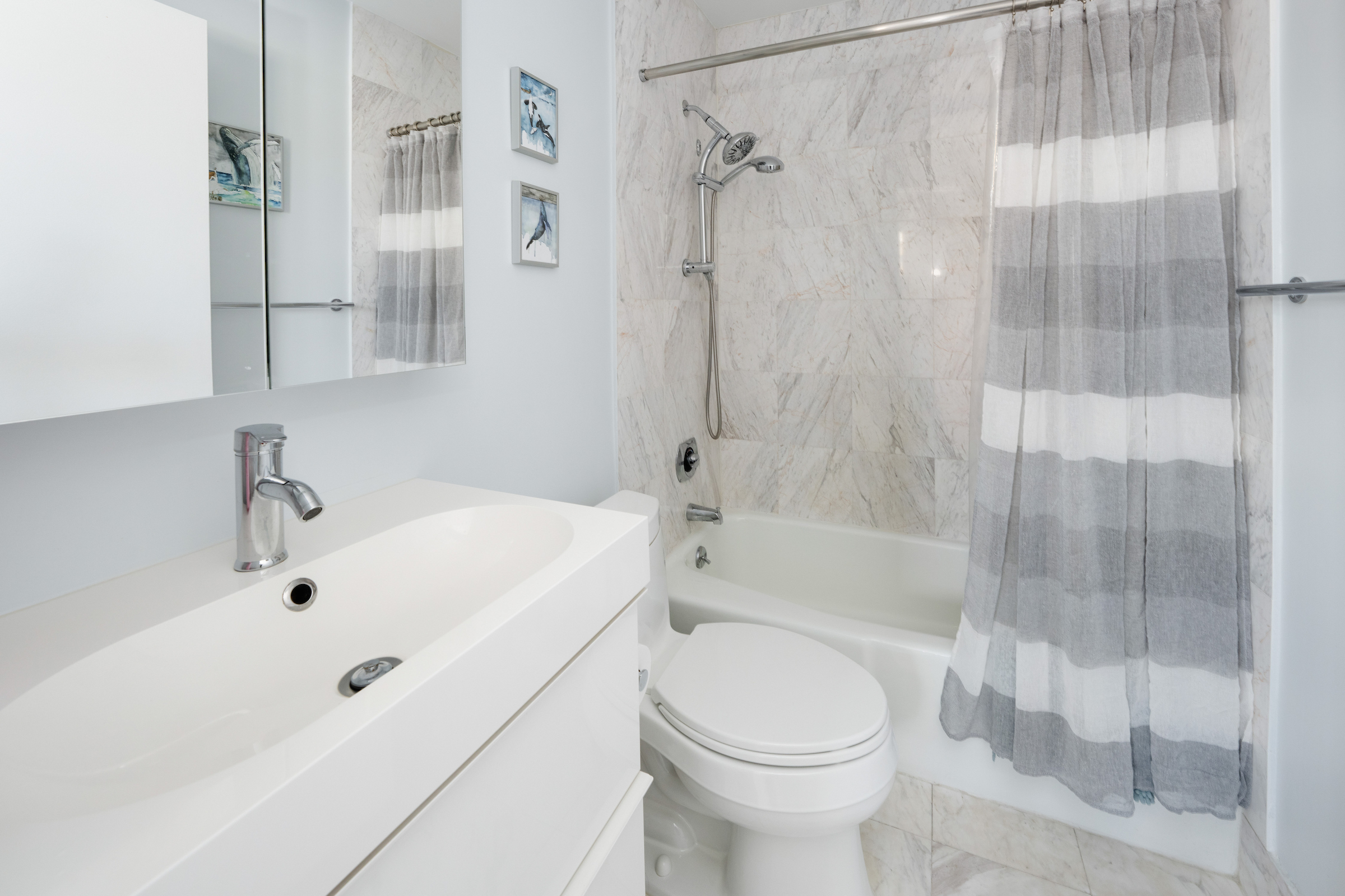 2373 Broadway, Unit 1425 Manhattan, NY 10024 - Photo 7 of 13 a bathroom with a white bath tub a toilet and a sink