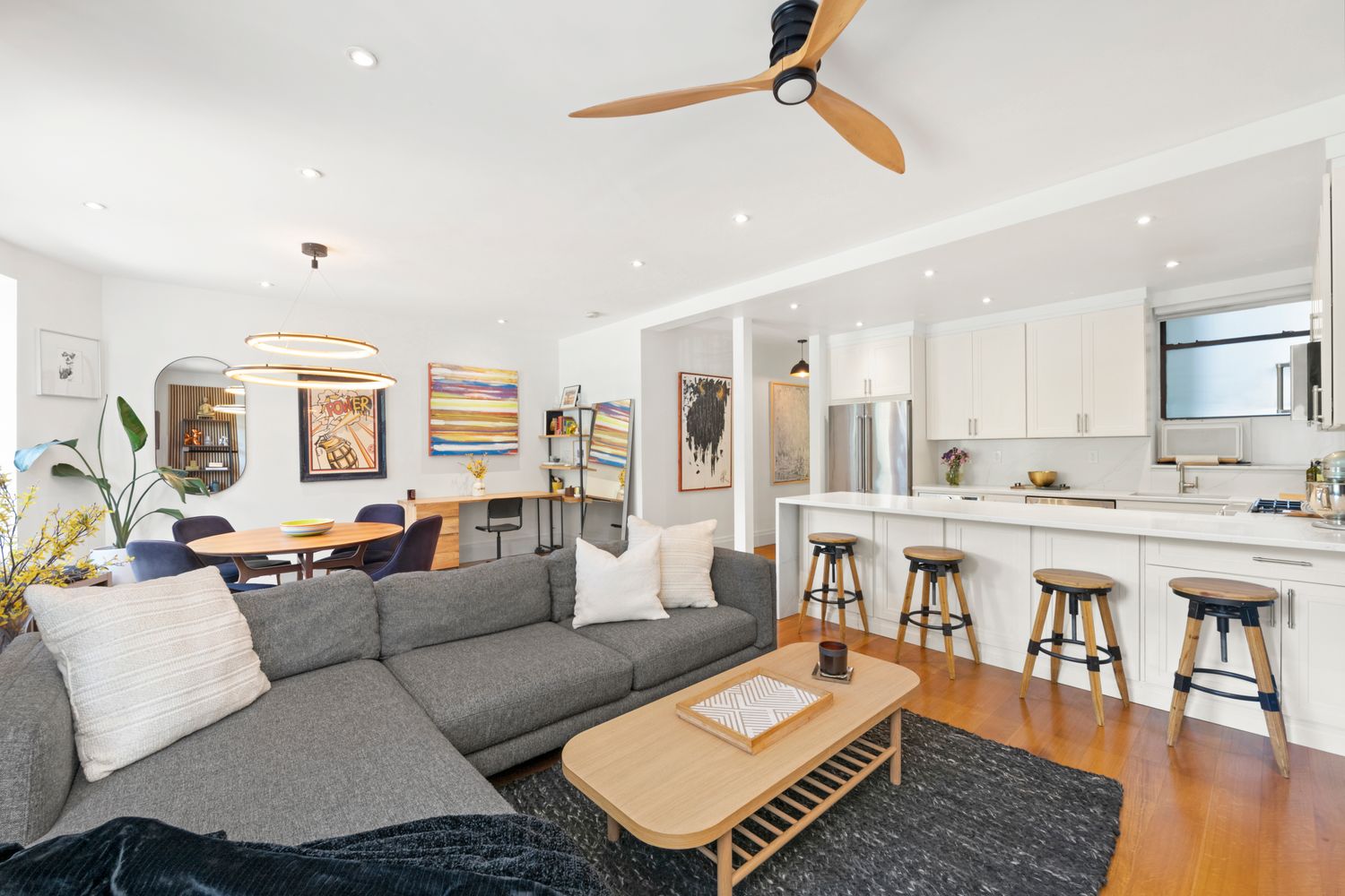 a living room with furniture and a wooden floor