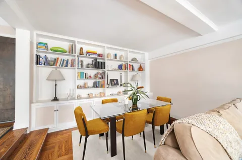 a dining room with furniture and a rug