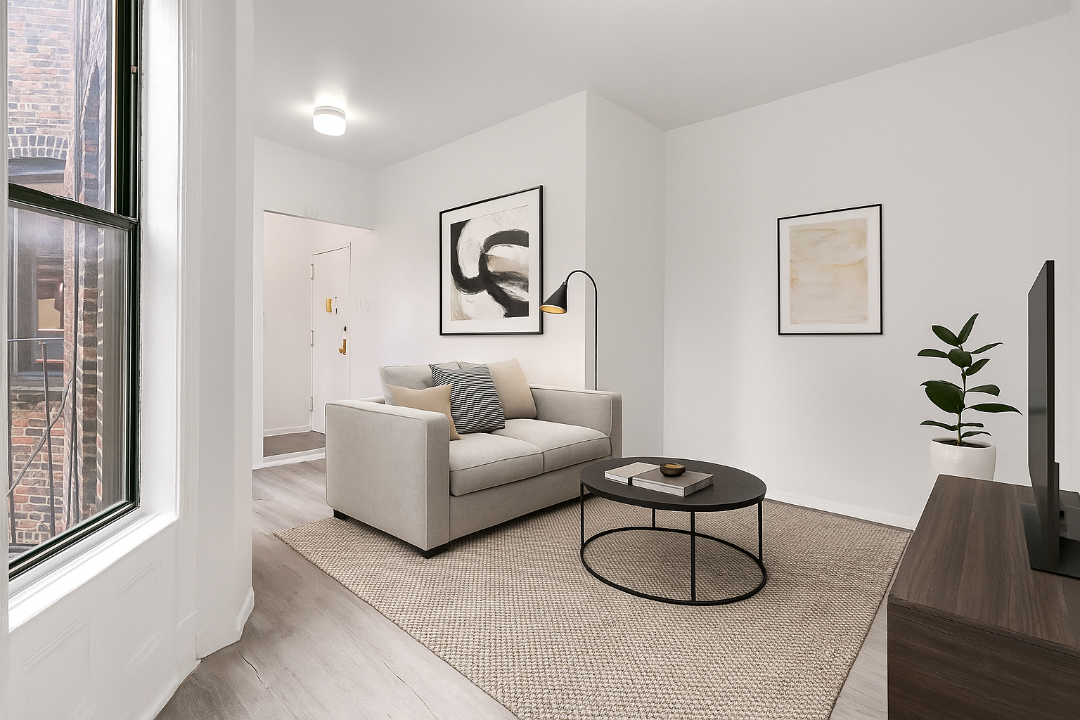 826 9th Avenue, Unit 5RS Manhattan, NY 10019 - Photo 5 of 15 a living room with furniture a couch and a window