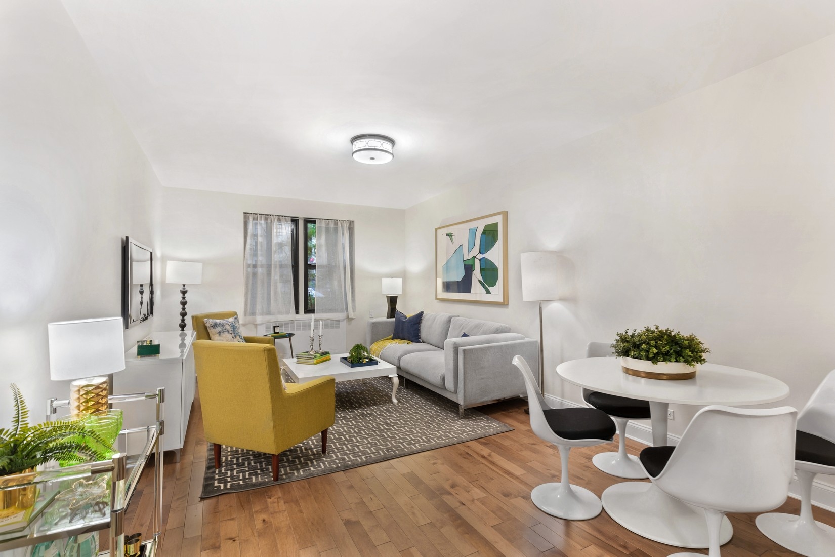 345 Riverside Drive, Unit 1E Manhattan, NY 10025 - Photo 1 of 5 a living room with furniture and a large window