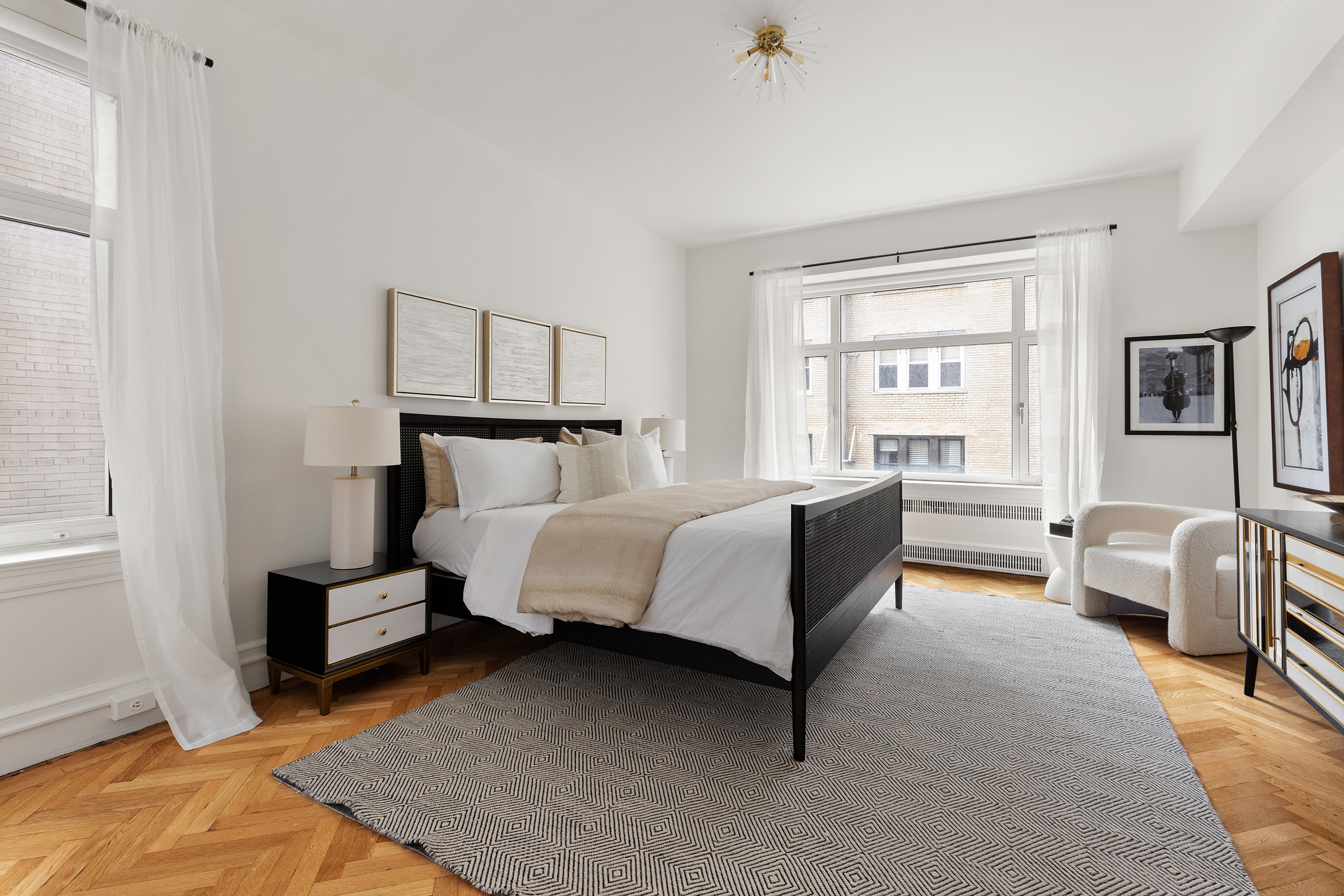 150 Central Park South, Unit 1010 Manhattan, NY 10019 - Photo 4 of 9 a bedroom with a bed and a couch