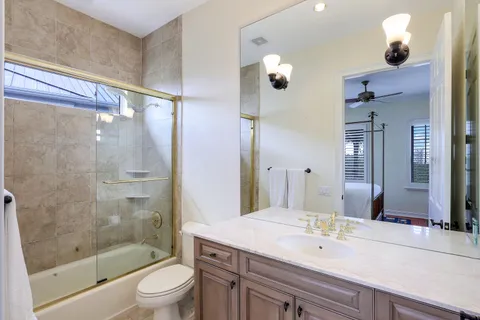 a bedroom with a bed and a ceiling fan