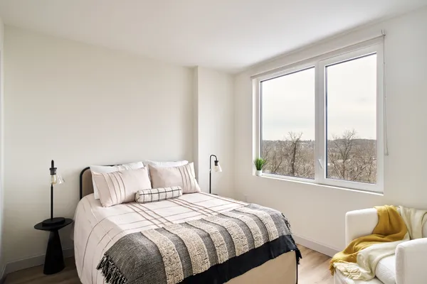 a bedroom with bed and a window