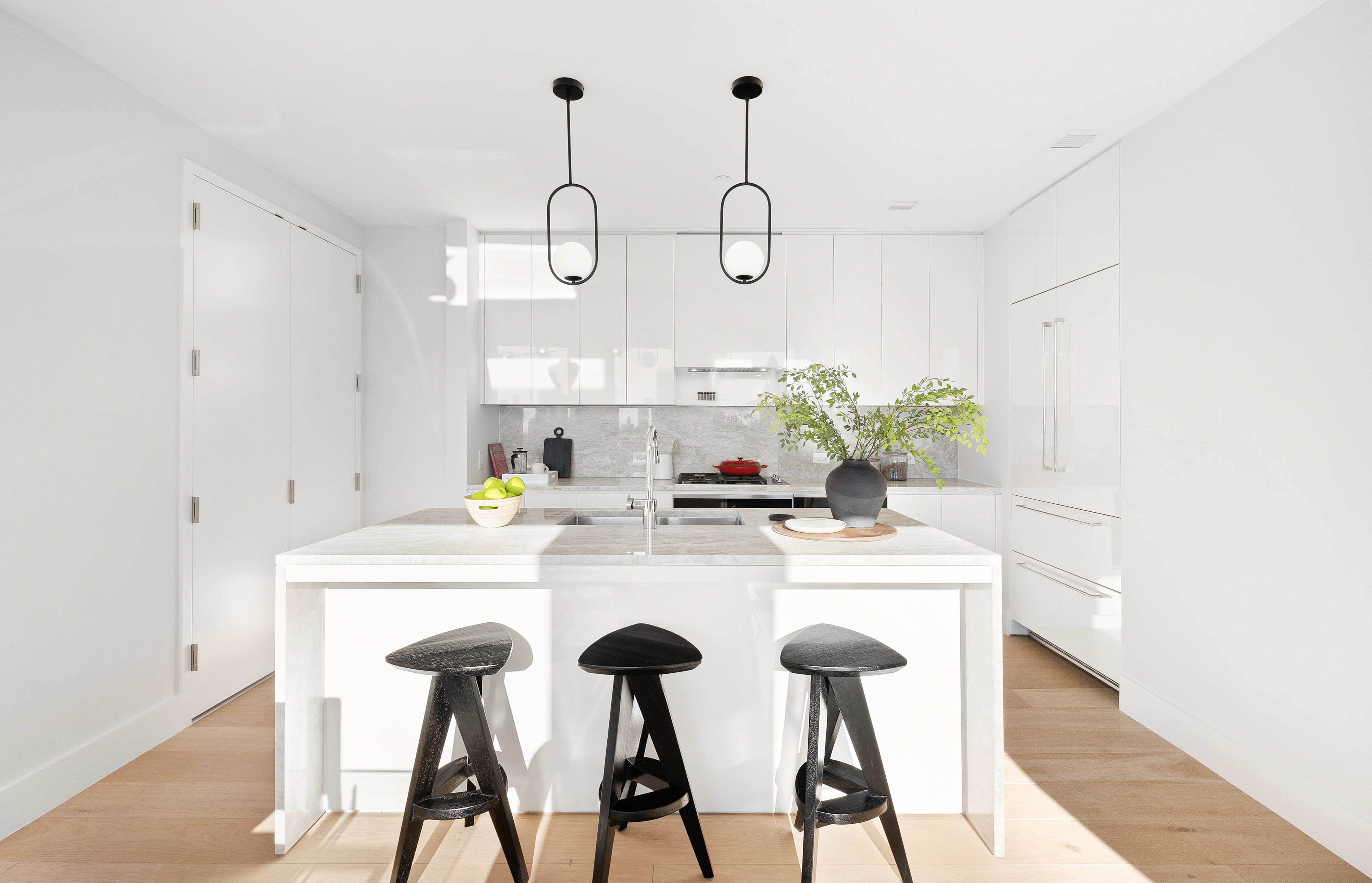 15 West 61st Street, Unit PH1C Manhattan, NY 10023 - Photo 9 of 26 a kitchen with cabinets and chandelier