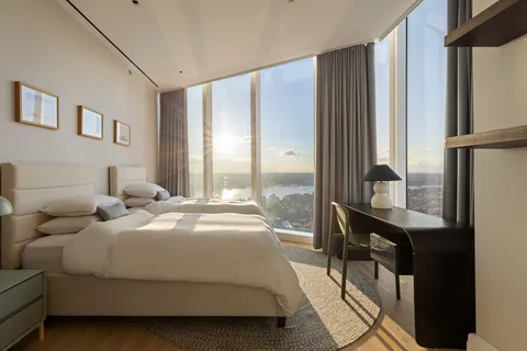 a bedroom with a bed window and a table
