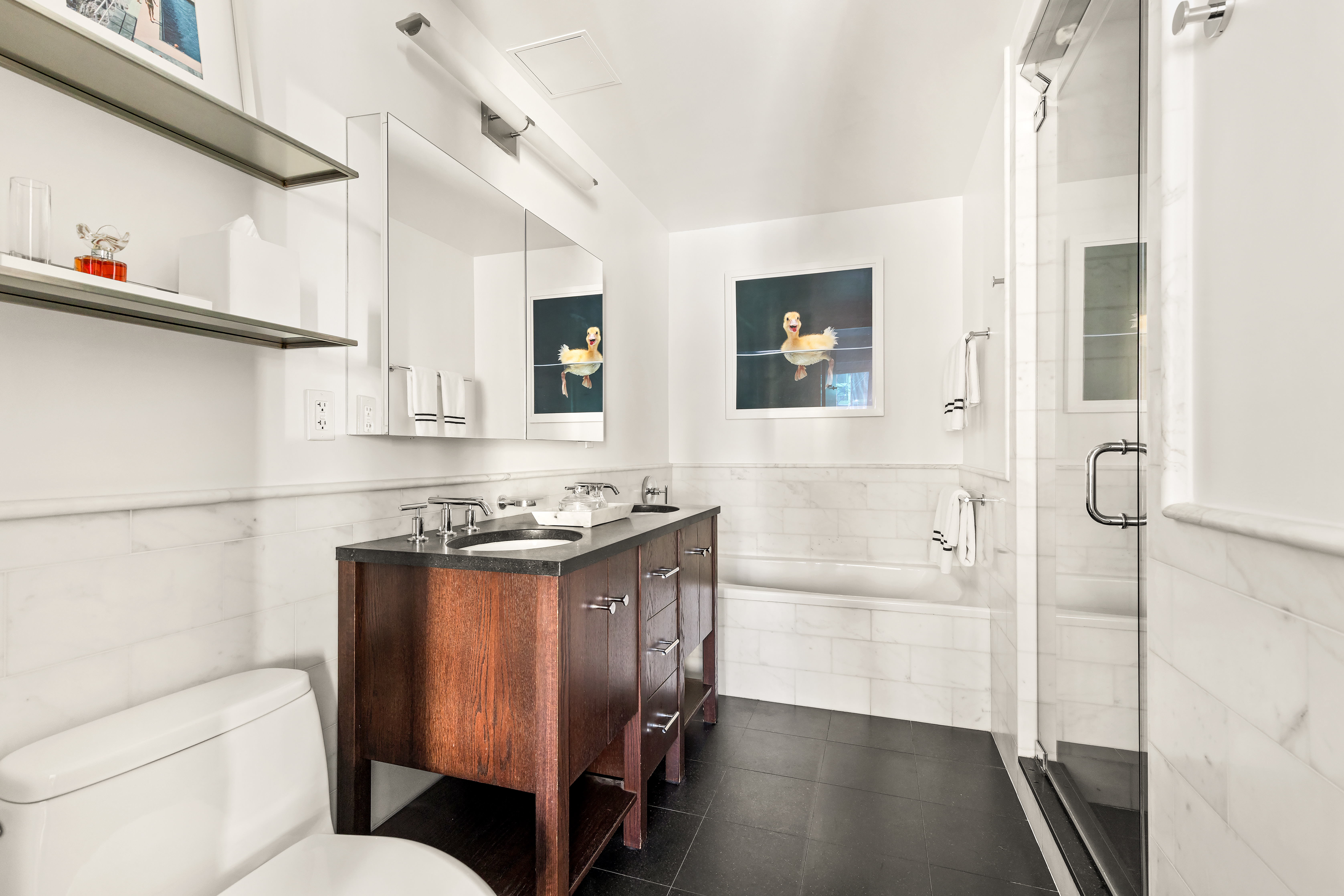 454 West 54th Street, Unit 5G Manhattan, NY 10019 - Photo 6 of 17 a bathroom with a granite countertop sink toilet and shower