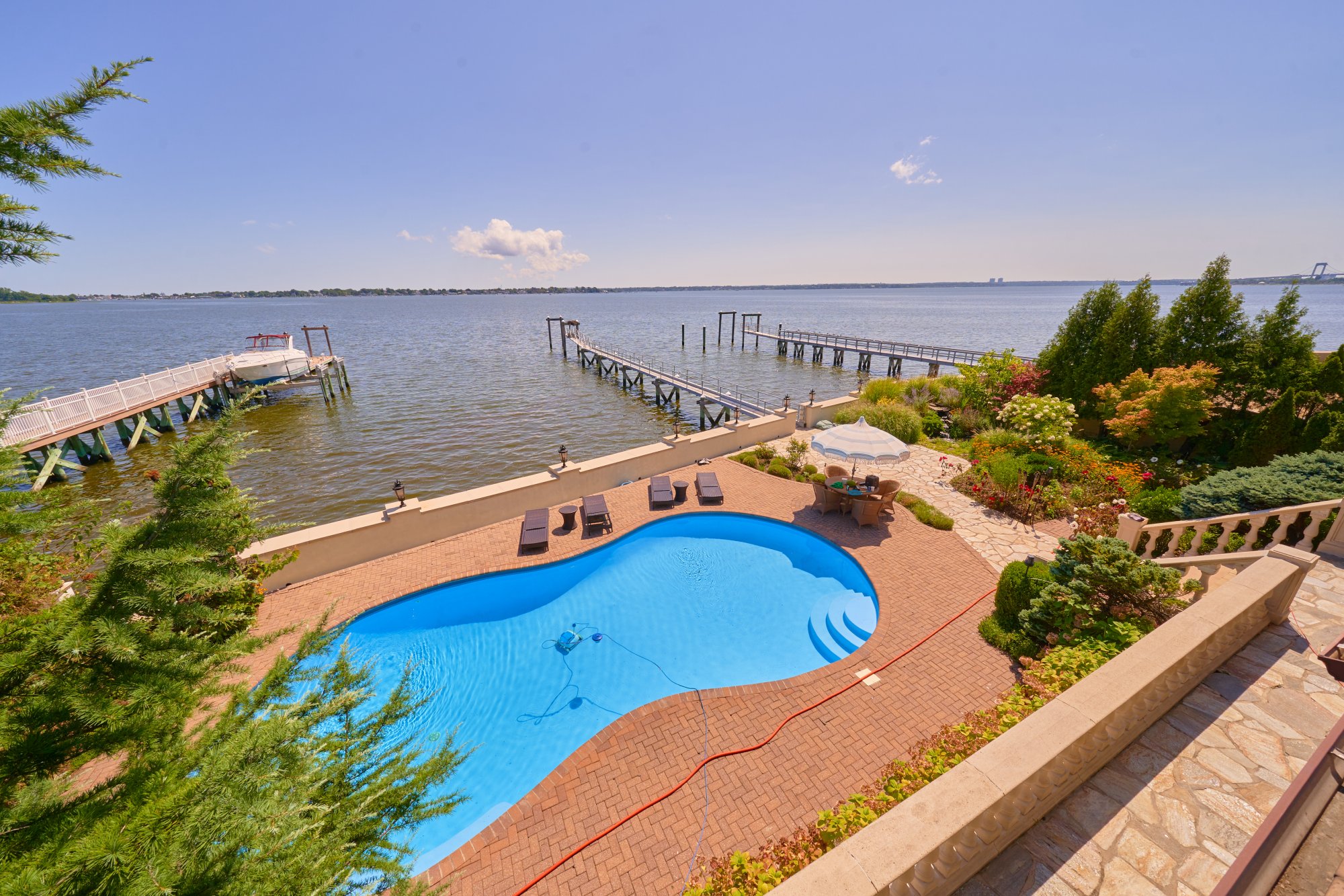 3411 Country Club Road Bronx, NY 10465 - Photo 39 of 54 a view of a swimming pool with outdoor seating and plants