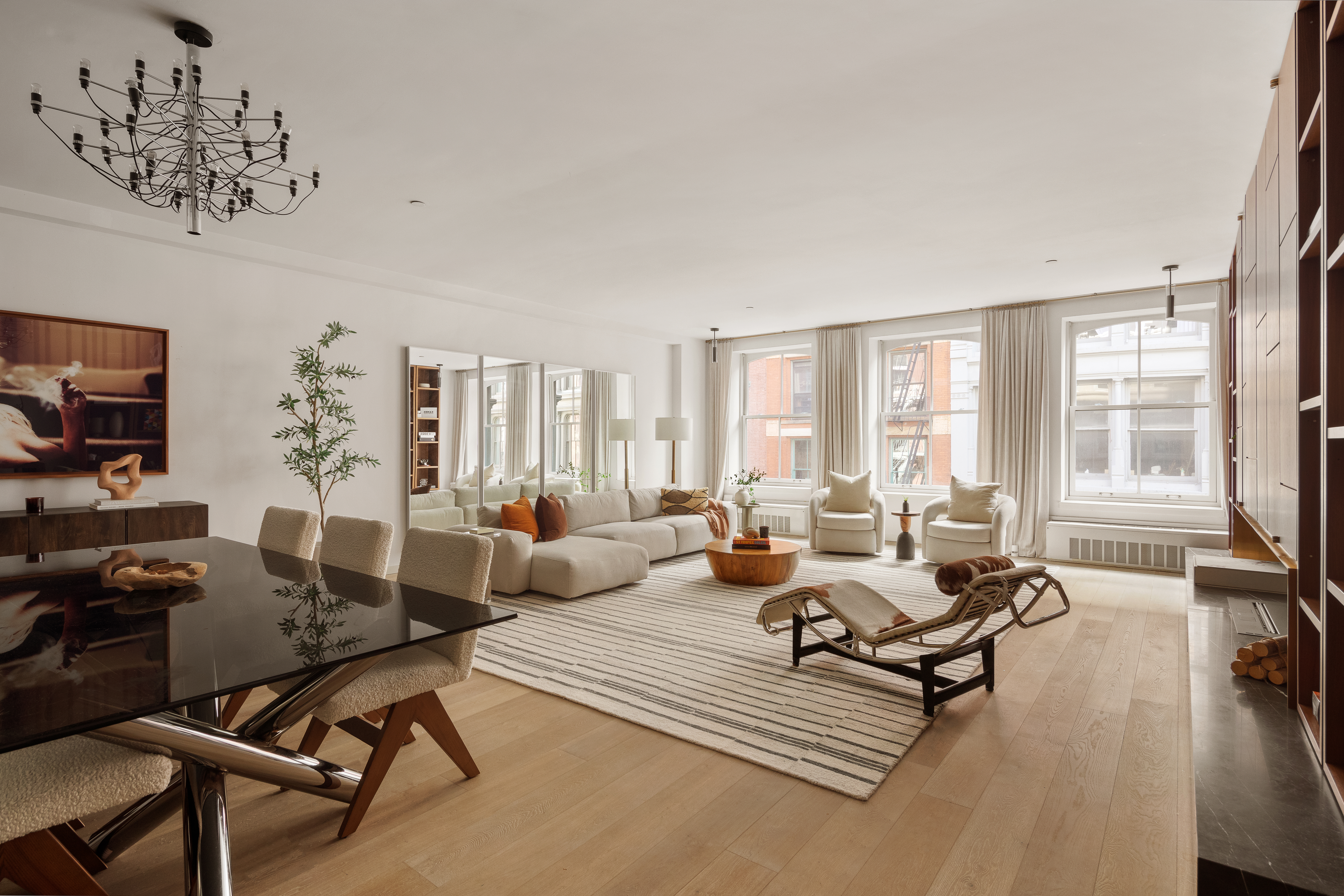 115 Mercer Street, Unit 4A Manhattan, NY 10012 - Photo 5 of 15 a living room with furniture hard wood floor and a floor to ceiling window