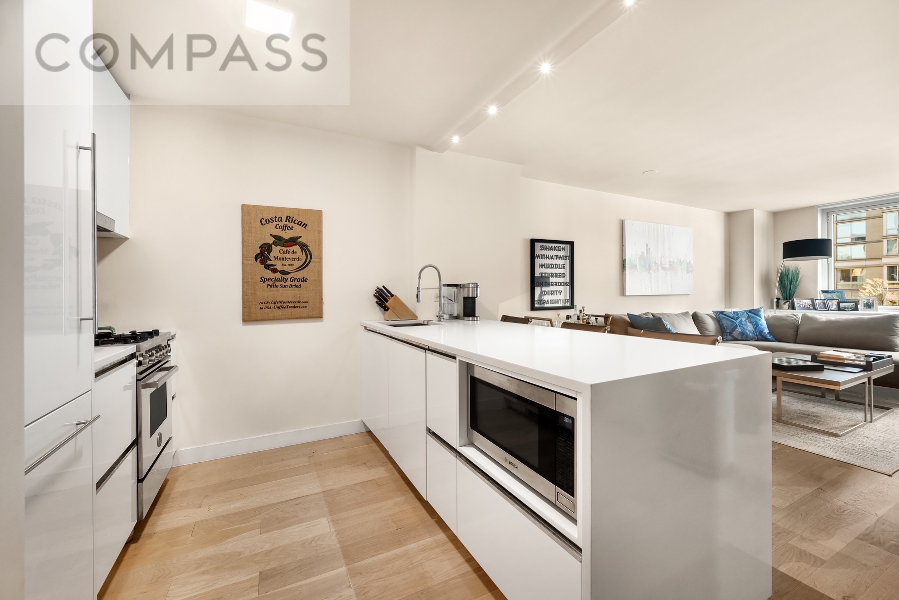 301 West 53rd Street, Unit 7H Manhattan, NY 10019 - Photo 2 of 11 a view of a kitchen with fridge and wooden floor